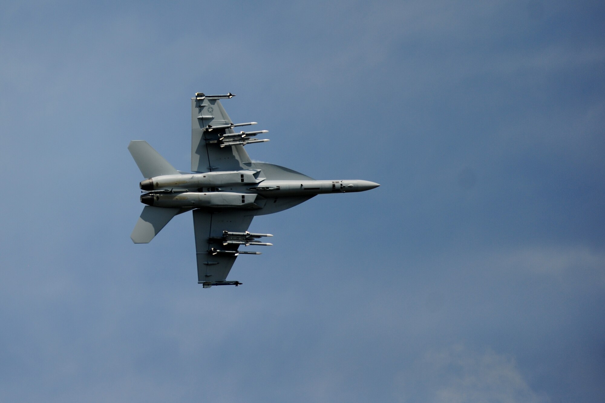 A U.S. Navy F/A-18F Super Hornet shows its underside during an aerial demonstration at the 2014 Royal International Air Tattoo on RAF Fairford, United Kingdom, July 12, 2014. Its agile frame allowed the Super Hornet to perform complex aerial maneuvers for a crowd of more than 30,000 people. (U.S. Air Force photo by Staff Sgt. Jarad A. Denton/Released) 
