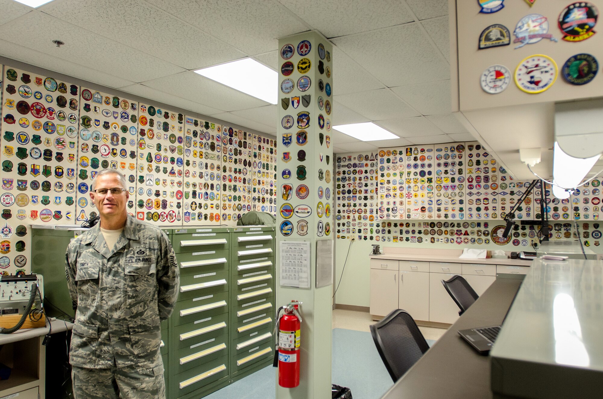 The Kentucky Air National Guard’s outgoing state command chief master sergeant, Chief Master Sgt. James Smith, started collecting a wide-ranging assortment of military unit patches more than 30 years ago. The collection, which is displayed in the 123rd Airlift Wing Operations Building in Louisville, Ky., has grown to 3001 patches and is believed to be the largest such display in the world. Smith is retiring from military service in ceremony to be held July 12, 2014, at the Kentucky Air National Guard Base. (U.S. Air National Guard photo by Senior Airman Joshua Horton)