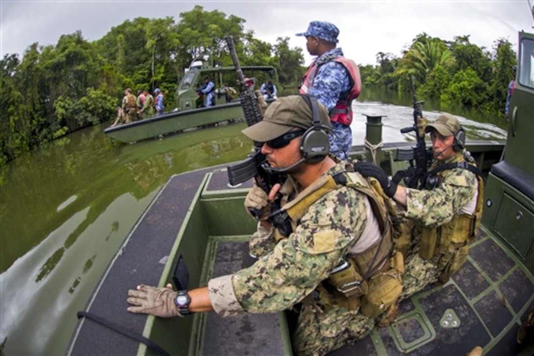 U.S. sailors coordinate insertion and extraction training with the Belize Special Boat unit as part of Southern Partnership Station 2014 on the Moho River, Belize, July 3, 2014. The training exercise focused on subject matter expert exchanges between the U.S. Navy and partner nation forces.