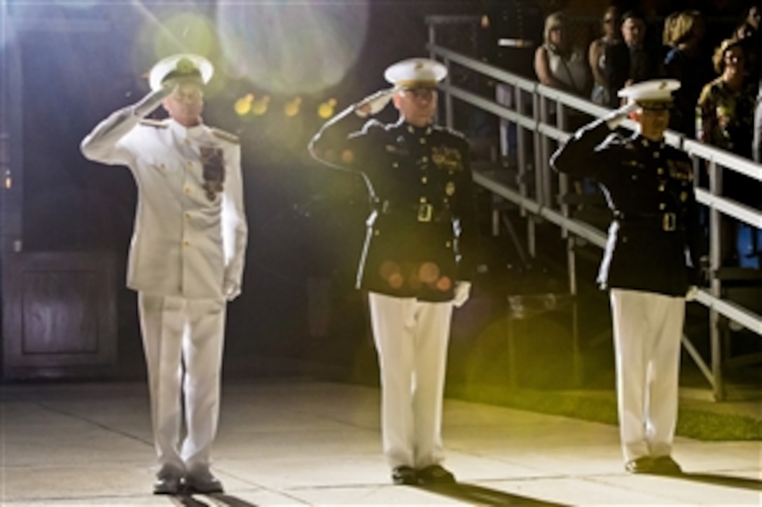 Navy Adm. James A. Winnefeld Jr., left, vice chairman of the Joint Chiefs of Staff, Marine Corps Assistant Commandant Gen. John M. Paxton Jr., center, and Marine Corps Col. Benjamin T. Watson, garrison commander, salute during the pass and review portion of the evening parade at Marine Barracks Washington, D.C., July 11, 2014. The Marines held the parade in Winnefeld's honor.