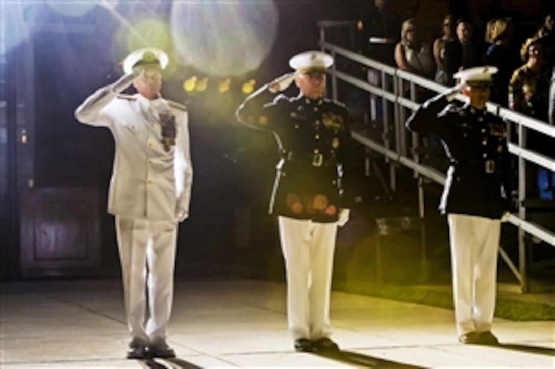 Navy Adm. James A. Winnefeld Jr., left, vice chairman of the Joint Chiefs of Staff, Marine Corps Assistant Commandant Gen. John M. Paxton Jr., center, and Marine Corps Col. Benjamin T. Watson, garrison commander, salute during the pass and review portion of the evening parade at Marine Barracks Washington, D.C., July 11, 2014. The Marines held the parade in Winnefeld's honor.