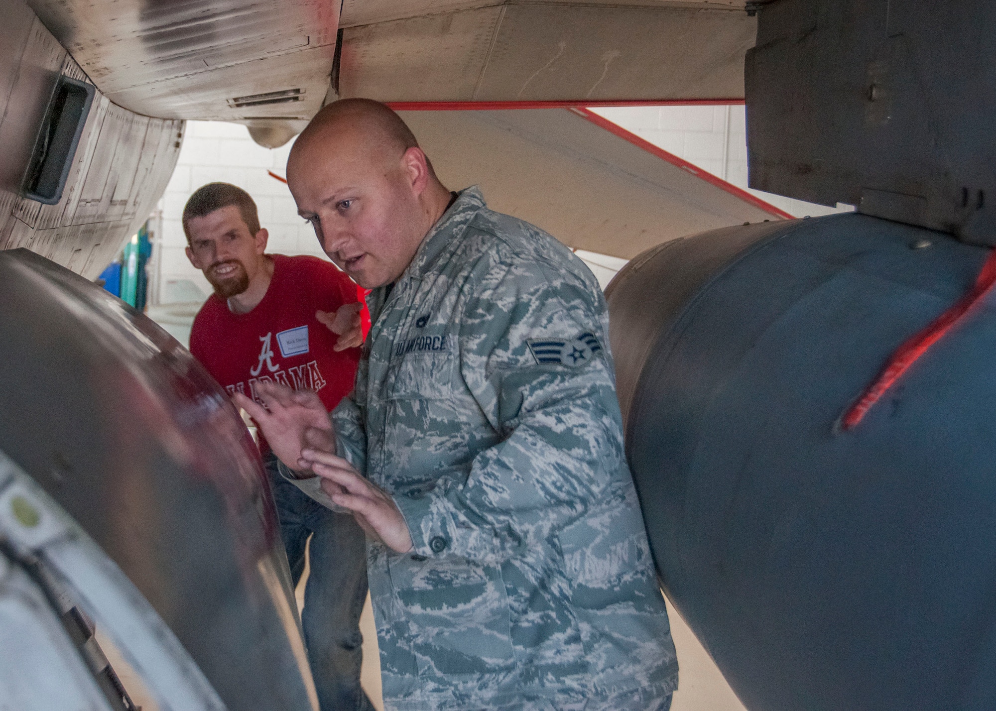 Senior Airman Tyler Hoffman, a reservist with the 419th Fighter Wing Aircraft Maintenance Squadron, explains his military duties with the F-16 to his civilian employer Rick Davis of Fresenius Medical Care. Davis, along with other civilian employers, was able to get a peek at his employee’s reserve mission as part of the wing’s Employer Appreciation Day. (U.S. Air Force photo/Staff Sgt. Crystal Charriere)