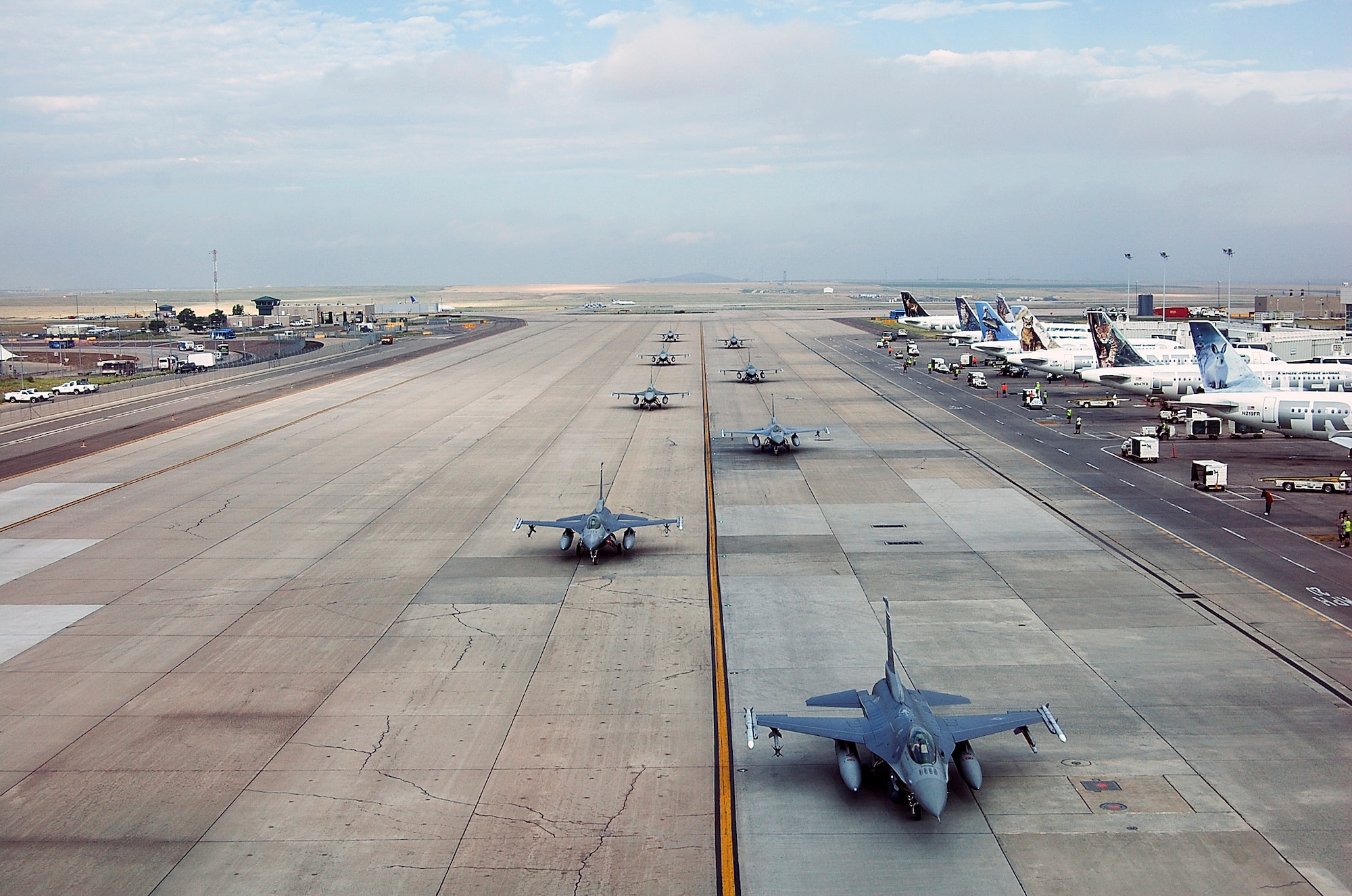 F-16s from the 140th Wing, Colorado Air National Guard begin to return to Buckley Air Force Base July 12, 2014, slightly ahead of schedule, after spending approximately three months at Denver International Airport while the base runway was being reconstructed. Despite relocating their entire flying operations, the wing managed to provide uninterrupted support to their Aerospace Control Alert mission 24/7 throughout the transition to DIA and back to Buckley AFB. (Air National Guard Photo by Capt. Kinder Blacke) 