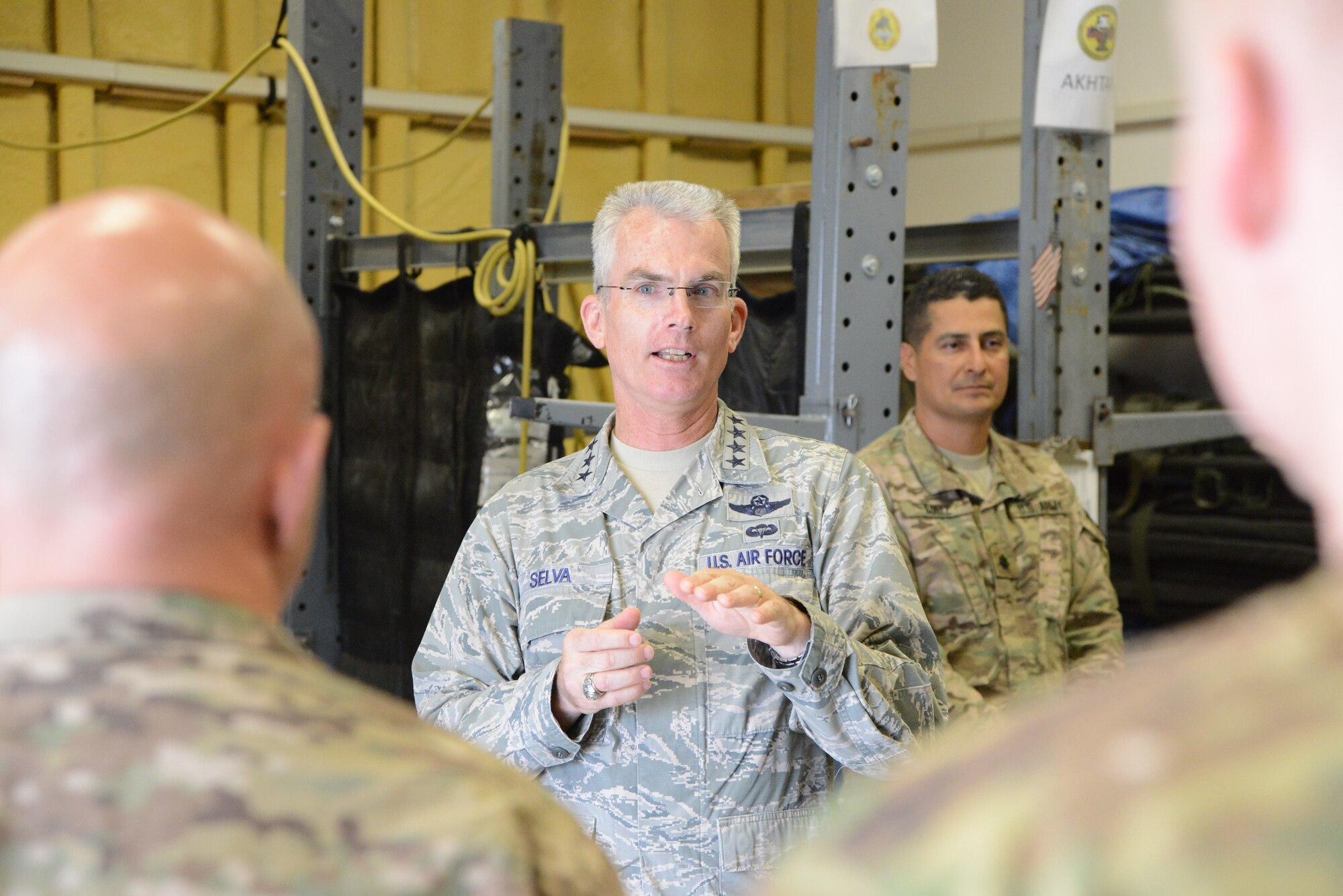 U.S. Air Force General Paul J. Selva, United States Transportation Command commander speaks with Airmen assigned to the 455th Expeditionary Aeromedical Evacuation Squadron at Bagram Airfield, Afghanistan July 10, 2014. Selva spoke with the team about the future of flight medicine and asked members about their concerns in their career field.  (U.S. Air Force photo by Master Sgt. Cohen A. Young/Released)