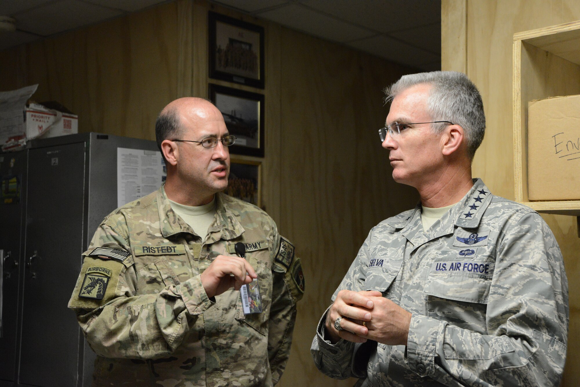 U.S. Army Col. David E. Ristedt, the NATO medical advisor and U.S. Forces Afghanistan Command Surgeon speaks with U.S. Air Force General Paul J. Selva, United States Transportation Command commander about the importance of the 455th Expeditionary Aeromedical Evacuation Squadron during Gen. Selva’s visit to Bagram Airfield, Afghanistan July 10, 2014. Selva spoke with 455 EAES members about the future of flight medicine and asked about their concerns in the medical career field.  (U.S. Air Force photo by Master Sgt. Cohen A. Young/Released)