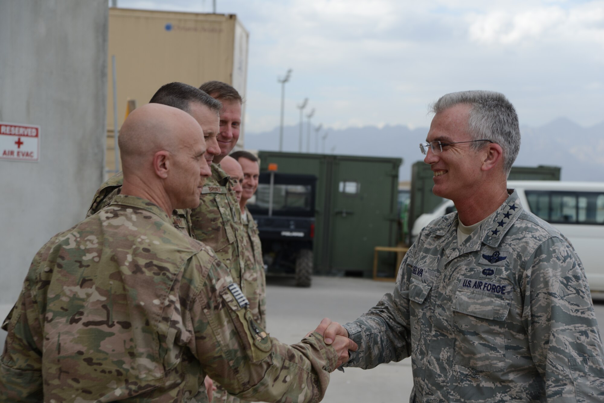 U.S. Air Force General Paul J. Selva, United States Transportation Command commander shakes hands with U.S. Air Force Col. Robert S. Jobe, 455th Expeditionary Operations Group commander, upon arriving at the 455th Expeditionary Aeromedical Evacuation Squadron at Bagram Airfield, Afghanistan July 10, 2014. Selva spoke with the team about the future of flight medicine and asked members about their concerns in their career field.  (U.S. Air Force photo by Master Sgt. Cohen A. Young/Released)