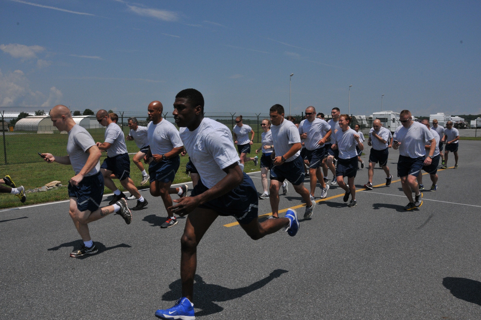 Reservists, assigned to the 512th Airlift Wing, begin a 5K race July 12, 2014, at Dover Air Force Base, Del. The race was part of Wingman Day, an event filled with social and physical fitness activities that promoted a culture of Airmen taking care of Airmen 24/7, 365 days a year. (U.S. Air Force photo/Senior Airman Joe Yanik)