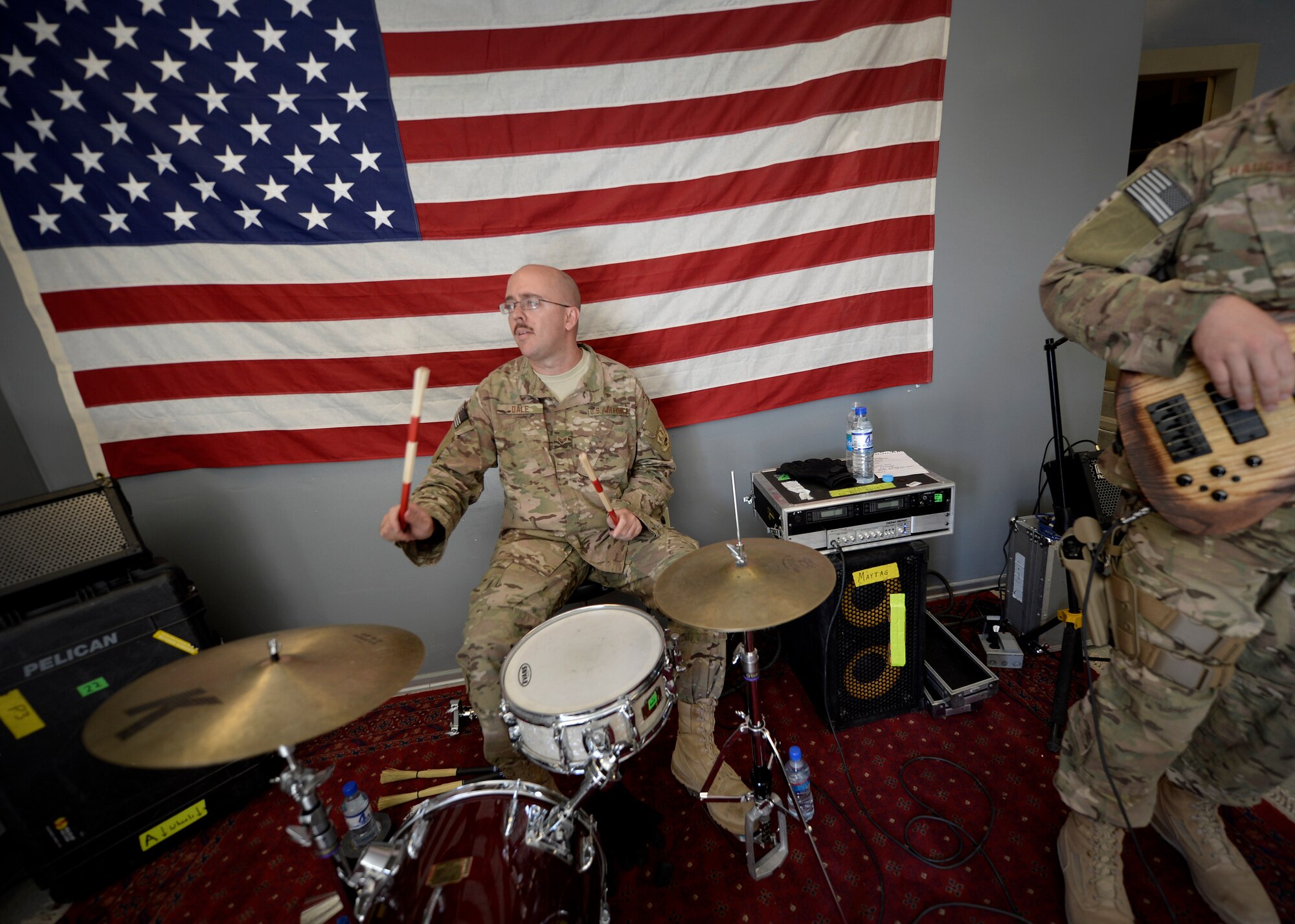 U.S. Air Force Senior Airman Jon-Marc Dale, Air Force Central Command Starlifter band member, plays the drums during a visit to Bagram Airfield, Afghanistan July 11, 2014.  The band played at several locations around the airfield to entertain service members. Dale is deployed from Scott Air Force Base, Ill. and a native of High Point, N.C. (U.S. Air Force photo by Staff Sgt. Evelyn Chavez/Released) 