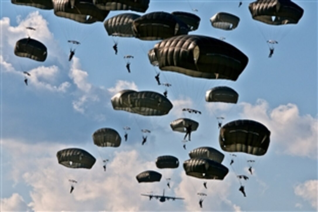U.S. paratroopers conduct an airborne operation in Nurmsi, Estonia, July 8, 2014. About 600 paratroopers from the brigade are in Estonia, Latvia, Lithuania and Poland as part of Operation Atlantic Resolve to demonstrate commitment to NATO obligations and sustain interoperability with allied forces. The paratroopers are assigned to 1st Squadron, 91st Cavalry Regiment, 173rd Airborne Brigade.