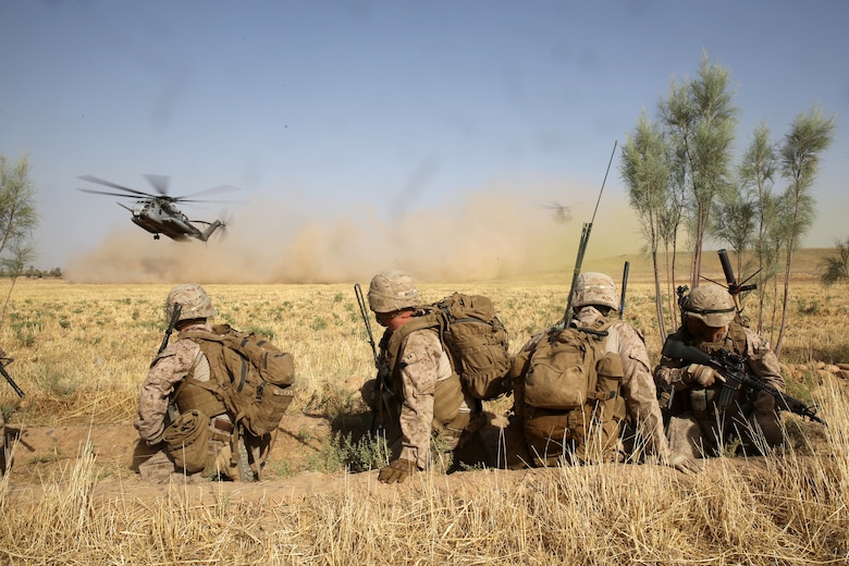 Marines with Bravo Company, 1st Battalion, 7th Marine Regiment, watch as CH-53E Super Stallion helicopters land in a field during a mission in Helmand province, Afghanistan, July 5, 2014. The company operated in Gereshk for three days and was involved in numerous kinetic engagements with Taliban insurgents.
(U.S. Marine Corps photo by Cpl. Joseph Scanlan / released)
