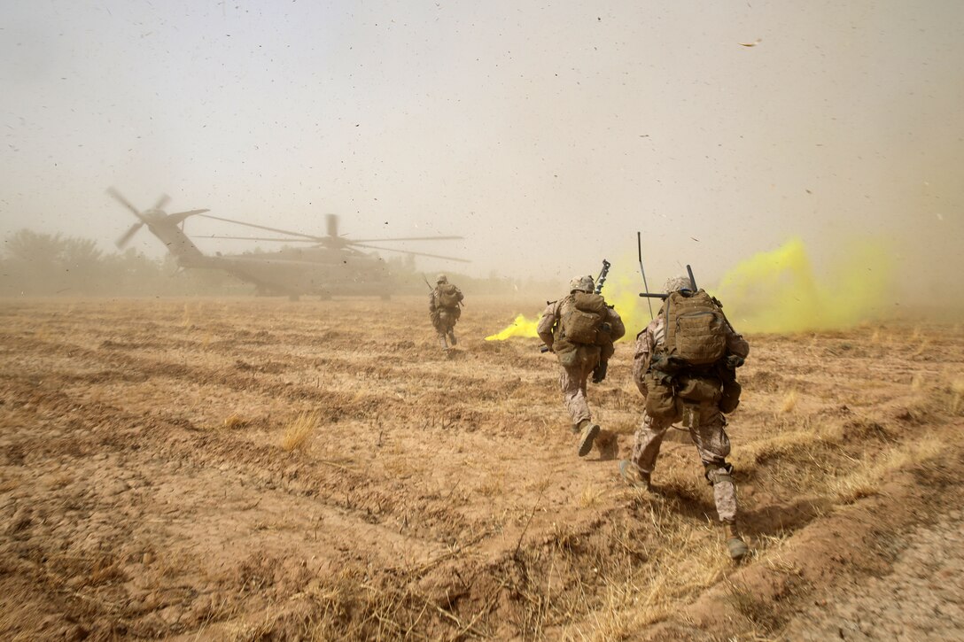 Marines with Bravo Company, 1st Battalion, 7th Marine Regiment, sprint across a field to load onto a CH-53E Super Stallion helicopter during a mission in Helmand province, Afghanistan, July 4, 2014. The company operated in Gereshk for three days and was involved in numerous kinetic engagements with Taliban insurgents.
(U.S. Marine Corps photo by Cpl. Joseph Scanlan / released)
