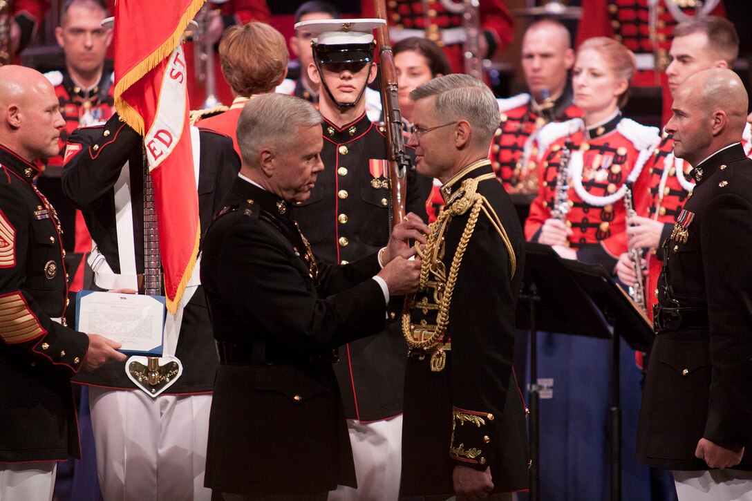 On July 12, 2014, at Rachel M. Schlesinger Concert Hall and Arts Center, Colonel Michael J. Colburn passed the John Philip Sousa Baton and command of “The President’s Own” United States Marine Band to Assistant Director Lt. Col. Jason K. Fettig. Following the ceremony Col. Colburn retired after serving 27 years in the Marine Corps. The event was officiated by Marine Corps Commandant General James F. Amos who awarded Col. Colburn with the Distinguished Service Medal. (U.S. Marine Corps photo by Staff Sgt. Brian Rust/released)
