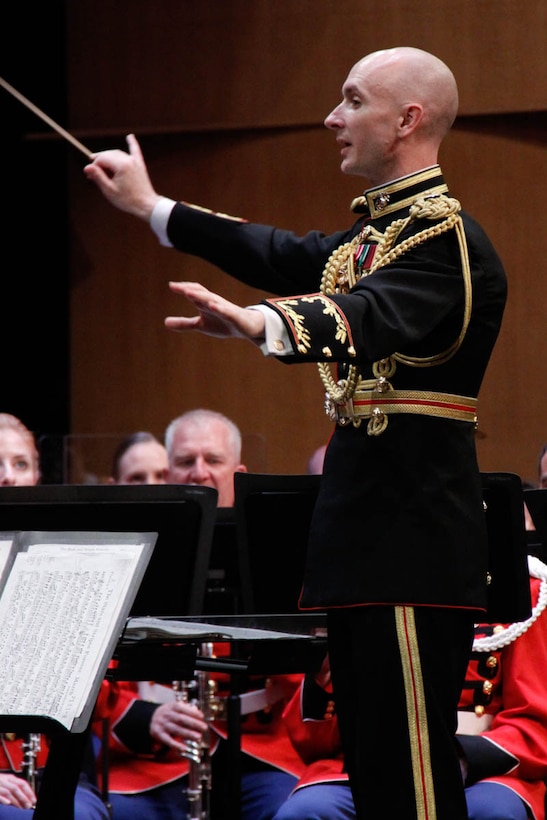 On July 12, 2014, Colonel Michael J. Colburn passed the John Philip Sousa Baton and command of “The President’s Own” United States Marine Band to Assistant Director Lt. Col. Jason K. Fettig. Following the ceremony Col. Colburn retired after serving 27 years in the Marine Corps. Pictured, Lt. Col. Fettig conducting Steven Bryant's Ecstatic Fanfare. (U.S. Marine Corps photo by Staff Sgt. Rachel Ghadiali/released)
