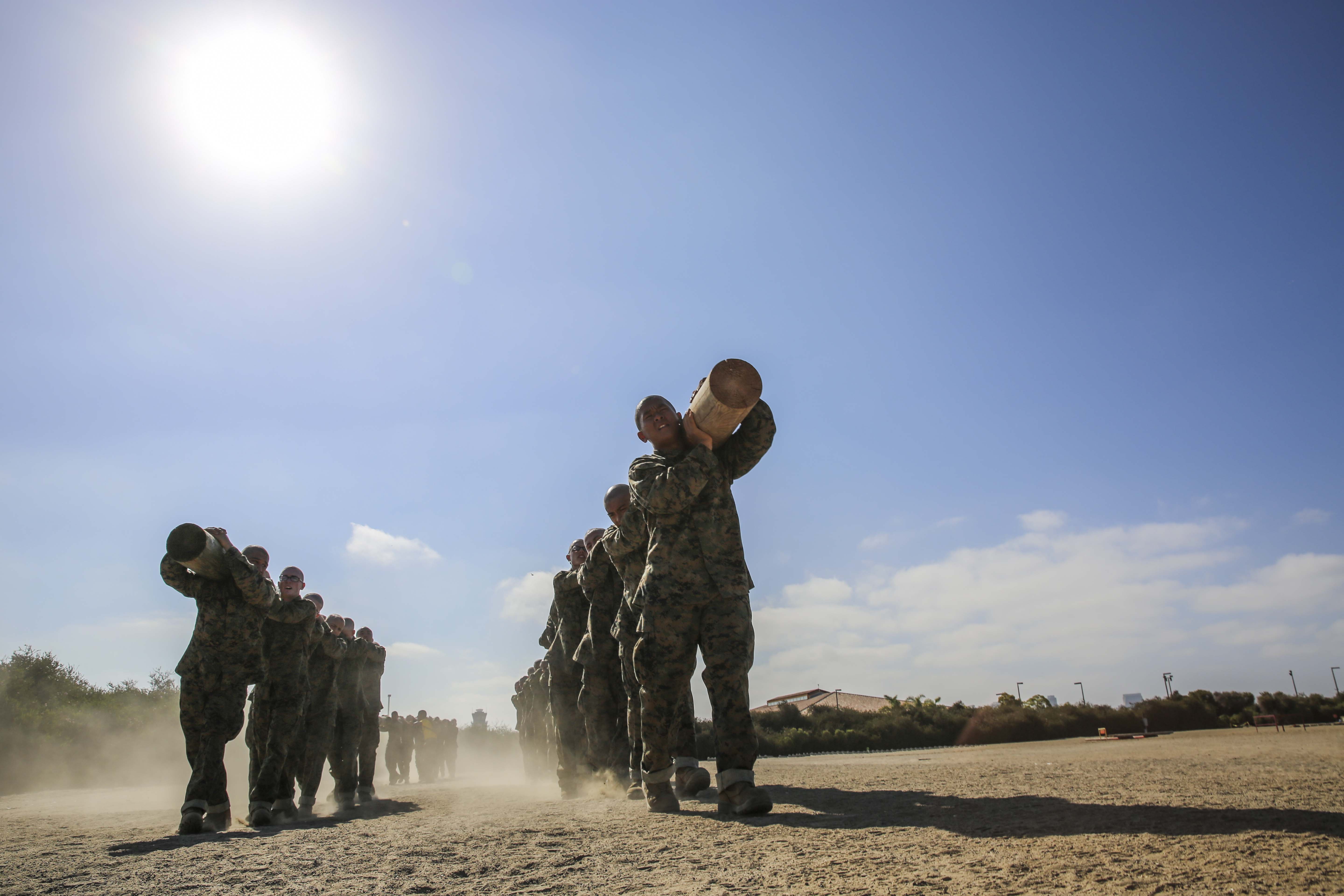 Recruits of Golf Company, 2nd Recruit Training Battalion, work together to finish a log drill exercise aboard Marine Corps Recruit Depot San Diego, July 8. The log drill exercise is one of many training events required for graduation from Marine Corps recruit training.