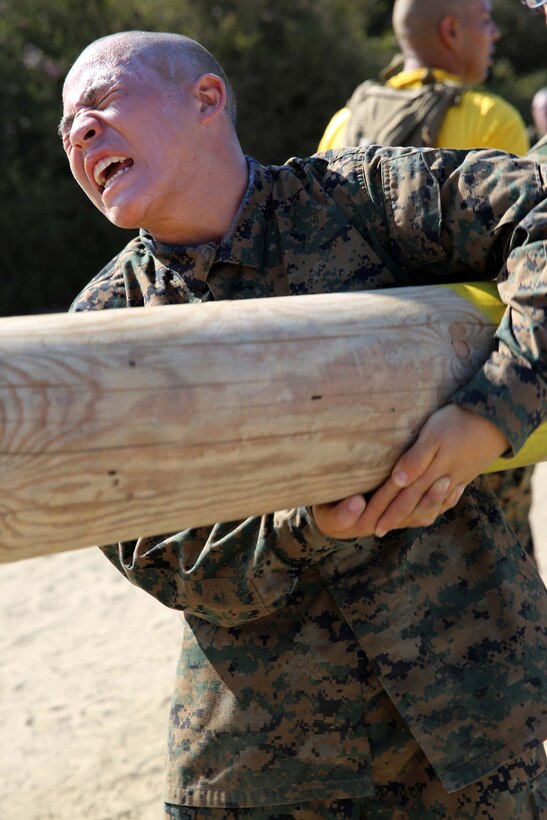 Recruit Luchou Xiong, Platoon 2147, Golf Company, 2nd Recruit Training Battalion, conducts log side bends during a log drill exercise at Marine Corps Recruit Depot San Diego, Calif., July 8. Log drill exercises are conducted in groups of seven and require teamwork to accomplish. Xiong is a Sacramento native and was recruited out of Recruiting Substation South Sacramento, Calif.