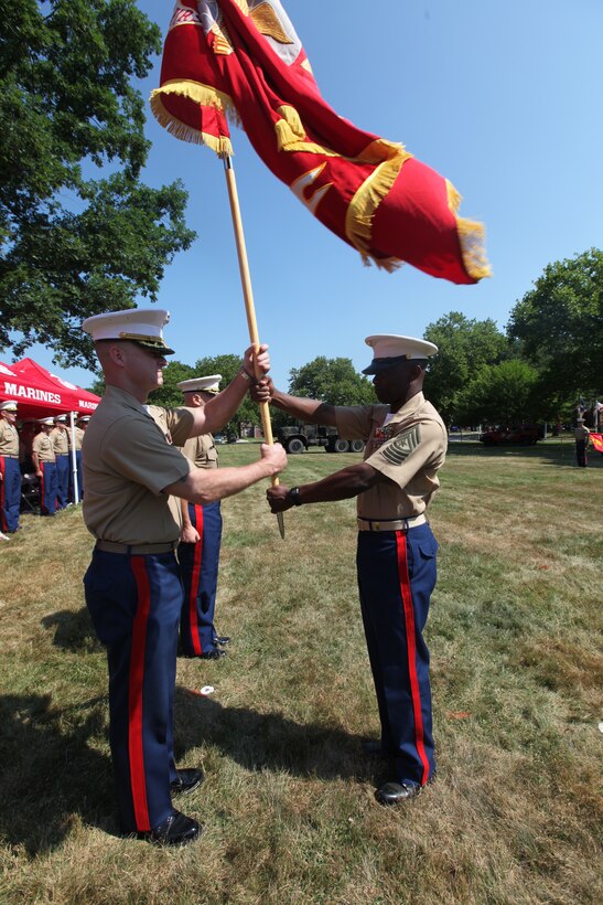 Col. J. J. Dill, commanding officer of 1st Marine Corps District, receives the unit colors from Sgt. Maj. Samuel Heyward, the 1MCD Sergeant Major, during a change of command ceremony on Naval Weapons Station Earle, July 11. During the ceremony, Dill relinquished his command to Col. James T. Iulo, the present commanding officer of 1MCD. (U.S. Marine Corps photo by Lance Cpl. Brandon Thomas).