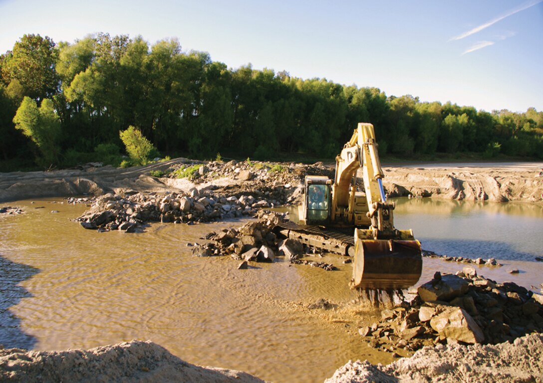 Construction contractor Mississippi Limestone, Inc., worked under the guidance of the Corps to construct notches and degrade dikes along the Mississippi River in 2013. (Photo by Bruce Reid and Ray Emerson)  