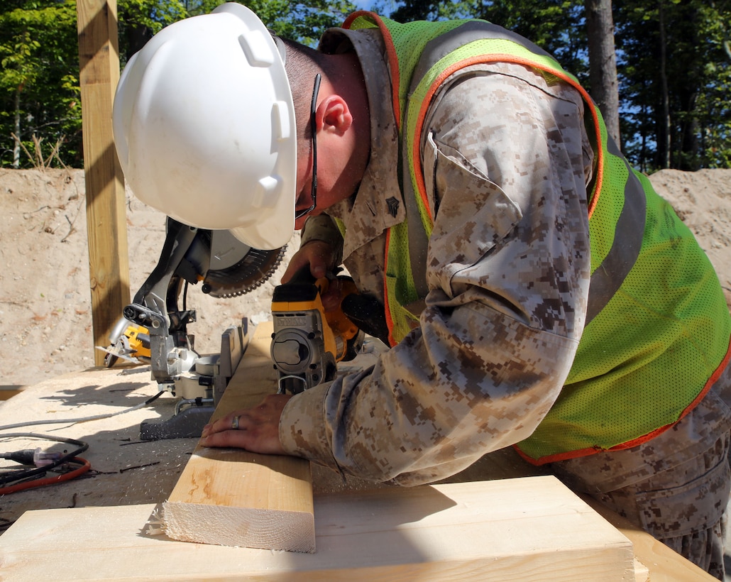 CAMP WILLIAM HINDS, RAYMOND, Maine – Sgt. Zackery Martinez, combat engineer with 6th Engineer Support Battalion and native of Battle Creek, Michigan, cuts a rafter beam to the correct measurements for a pavilion on the new 100-meter range being built for the Boy Scouts of America during the joint service Innovative Readiness Training on Camp William Hinds in Raymond, Maine, July 10, 2014. IRT Camp Hinds is a joint service initiative designed to provide service memebers with real-world training opportunities preparing them for their war-time missions while also supporting the needs of America’s underserved communities. (Photo by Sgt. Adwin Esters/Released 140710-M-JL916-033)