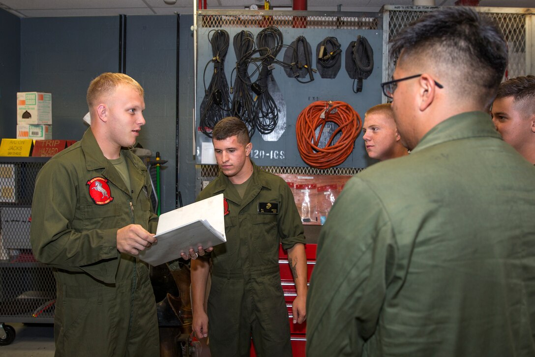 Sgt. Kevin McVey, desk sergeant and collateral duty inspector with Marine Heavy Helicopter Squadron (HMH) 465, goes over scheduled maintenance with his shift aboard Marine Corps Air Station Miramar, Calif., July 10. The desk sergeant acts as a middleman between maintenance control and the airframes mechanics. His responsibilities include delegating tasks, ordering parts and ensuring the Marines know what aircraft to fix and how to fix it.