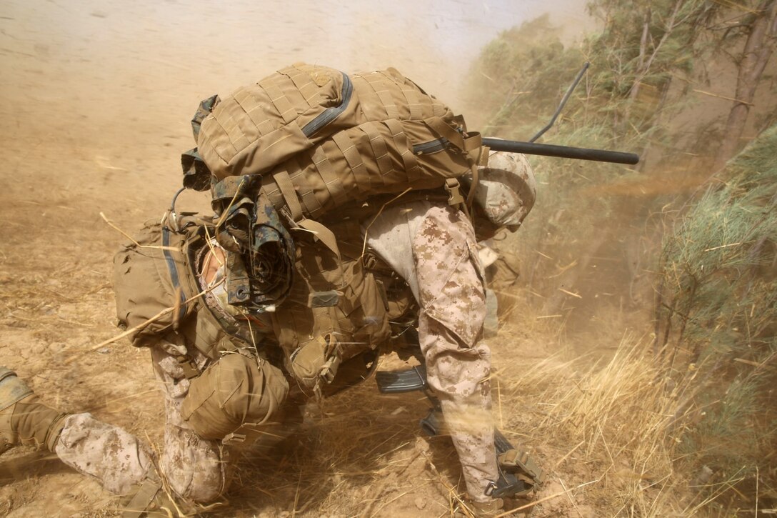Corporal Anthony Davis, fire team leader, Bravo Company, 1st Battalion, 7th Marine Regiment, shields himself from dirt and debris as two CH-53E Super Stallion helicopters land in a field during a mission in Helmand province, Afghanistan, July 4, 2014. Davis, a native of Poulsbo, Wash., and the company operated in Gereshk for three days and were involved in numerous kinetic engagements with Taliban insurgents.
(U.S. Marine Corps photo by Cpl. Joseph Scanlan / released)