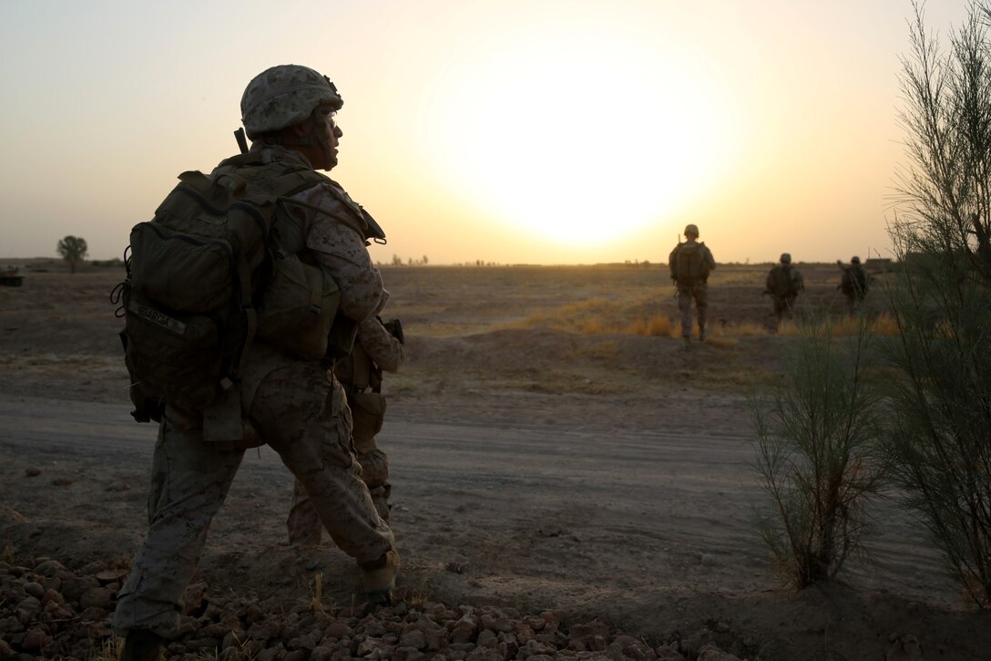 Corporal Eric Garcia, squad leader, Bravo Company, 1st Battalion, 7th Marine Regiment, scans the surrounding area while patrolling in Helmand province, Afghanistan, July 5, 2014. Garcia, a native of Waukegan, Ill., and the company operated in Gereshk for three days and were involved in numerous kinetic engagements with Taliban insurgents.
(U.S. Marine Corps photo by Cpl. Joseph Scanlan / released)