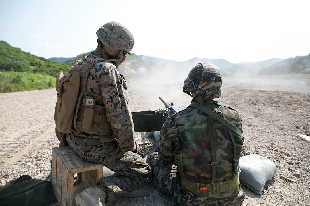 U.S. Marine Lance Cpl. Adam Alcala, left, supervises a Republic of Korea Marine during live-fire training June 18 as part of Korean Marine Exchange Program 14-8 at the Susungri Range in Pohang, South Korea. KMEP 14-8 is carried out in the spirit of the ROK-U.S. Mutual Defense Treaty, which was signed between the two nations October 1, 1953. The exercise strengthens the enduring alliance between South Korea and the U.S. and highlights the two countries’ commitment to the defense of South Korea and peace and security in the region. Alcala is a Harrison, Arkansas, native and military policeman with Company A, 3rd Law Enforcement Battalion, III Marine Expeditionary Force Headquarters Group, III MEF. (U.S. Marine Corps photo by Lance Cpl. Drew Tech/Released)