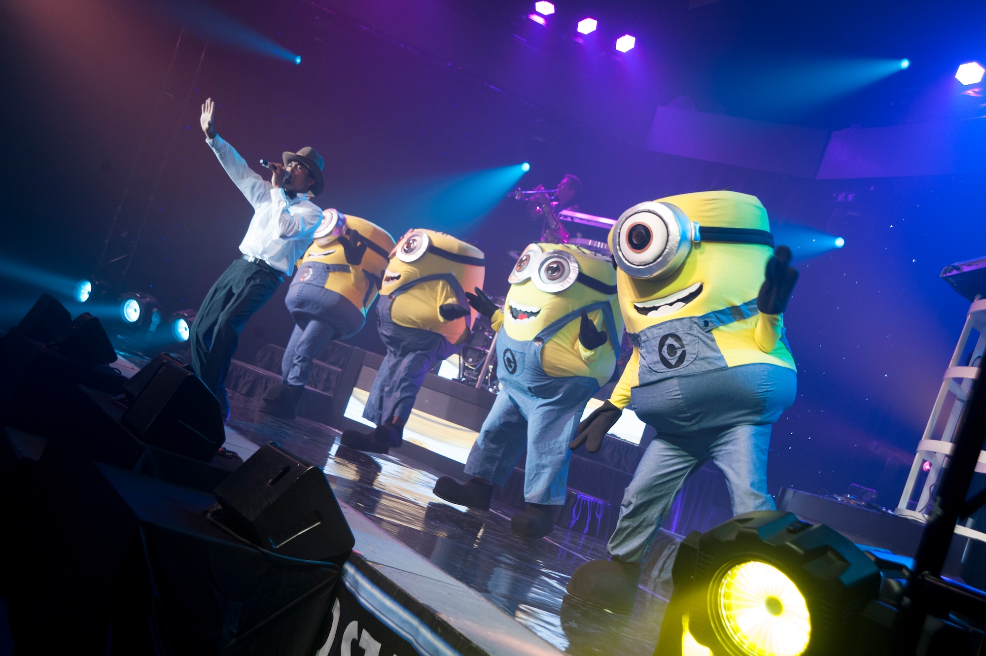 Senior Airman Charles Cooper, 509th Logistics Readiness Squadron vehicle operations journeyman, and Tops In Blue vocalist, sings on stage with characters from a popular children’s movie July 11, 2014, Cabrillo High School, Lompoc, Calif. Celebrating 60 years of tradition, Tops In Blue performed for Vandenberg personnel, families and members of the local community. (U.S. Air Force photo by Senior Airman Armando Aparicio/Released)