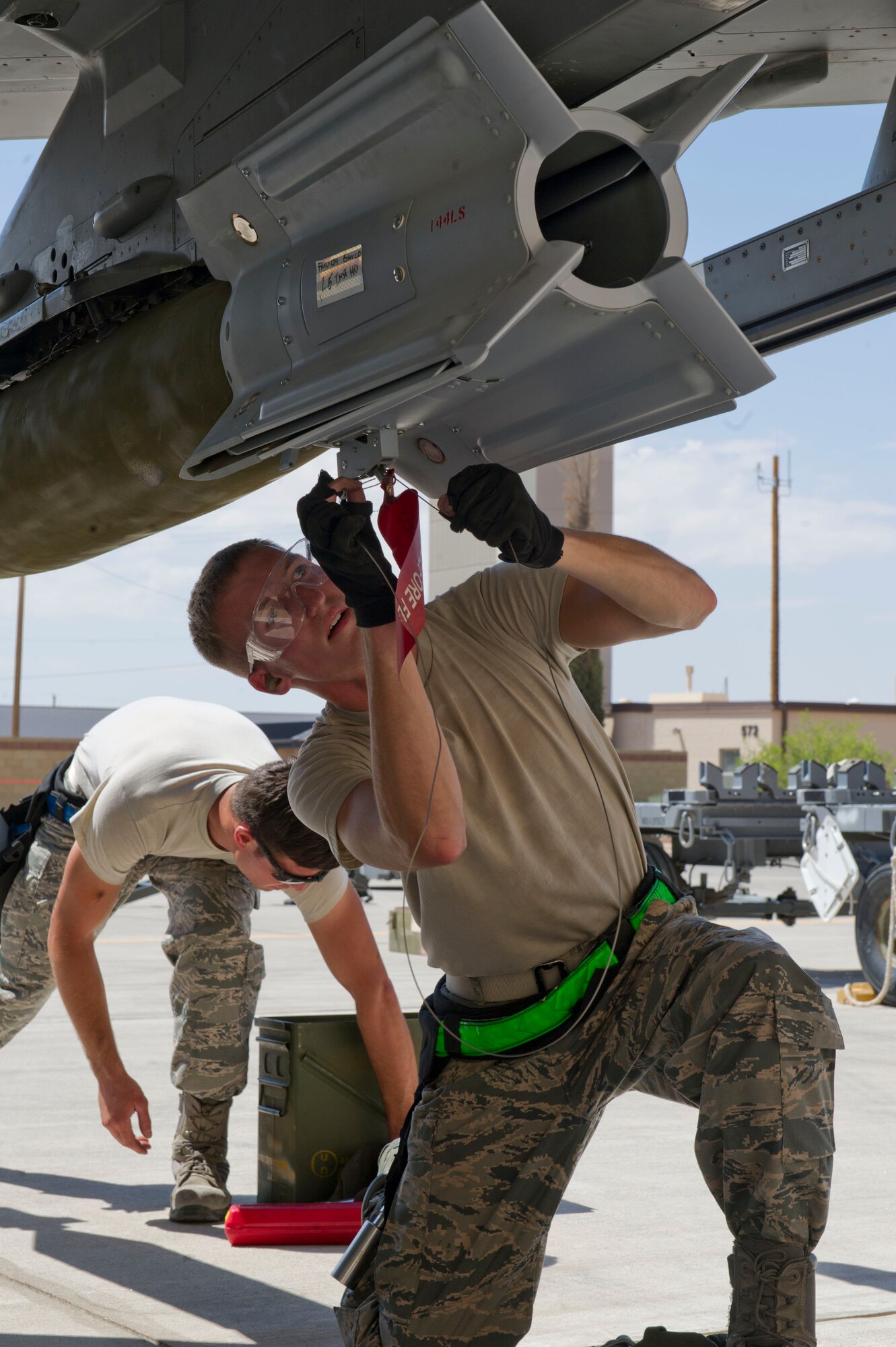 Senior Airman Joshua Parker, 54th Fighter Group F-16 Fighting Falcon weapons load crew 102 member, secures a GBU-38 bomb to the F-16 during the third quarterly load crew competition at Holloman Air Force Base, N.M., July 11. The F-16 load crew participated in the competition to have their skills evaluated alongside the MQ-9 Reaper load crews. For the competition, points are awarded for weapons-loading, toolkit inspection, and uniform inspection. (U.S. Air Force Staff Sgt. E’Lysia A. Wray/Released)