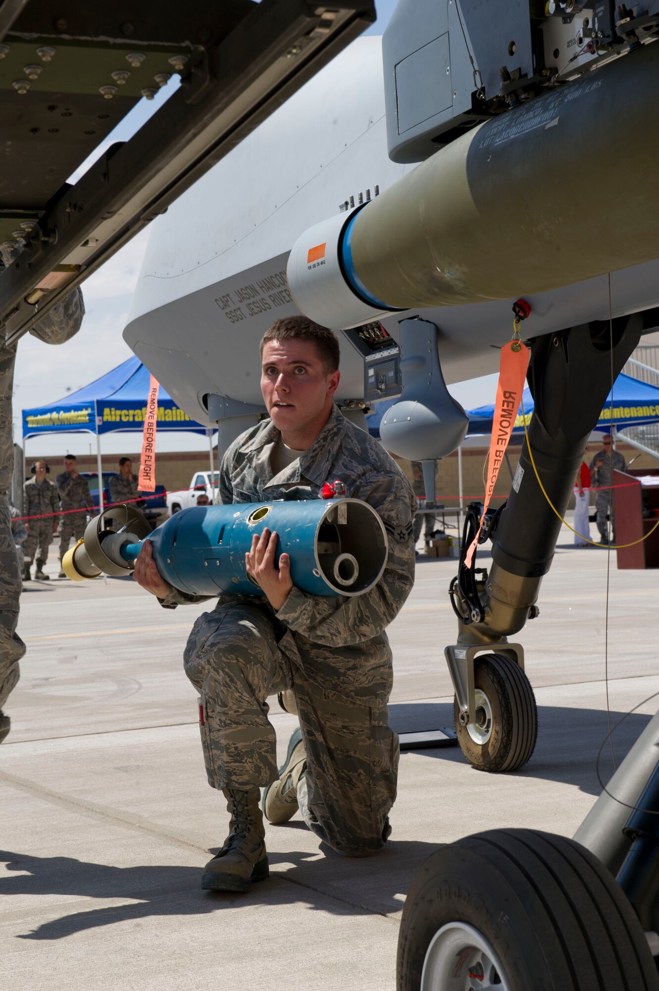 Airman 1st Class Christopher Williamson, 49th Maintenance Group MQ-9 Reaper weapons load crew 58 member, prepares to load the laser-guided portion of the GBU-12 Paveway bomb during the third quarterly load crew competition at Holloman Air Force Base, N.M., July 11. The MQ-9 load crew participated in the competition to have their skills evaluated alongside the F-16 Fighting Falcon load crews. For the competition, points are awarded for weapons-loading, toolkit inspection, and uniform inspection. (U.S. Air Force Staff Sgt. E’Lysia A. Wray/Released)