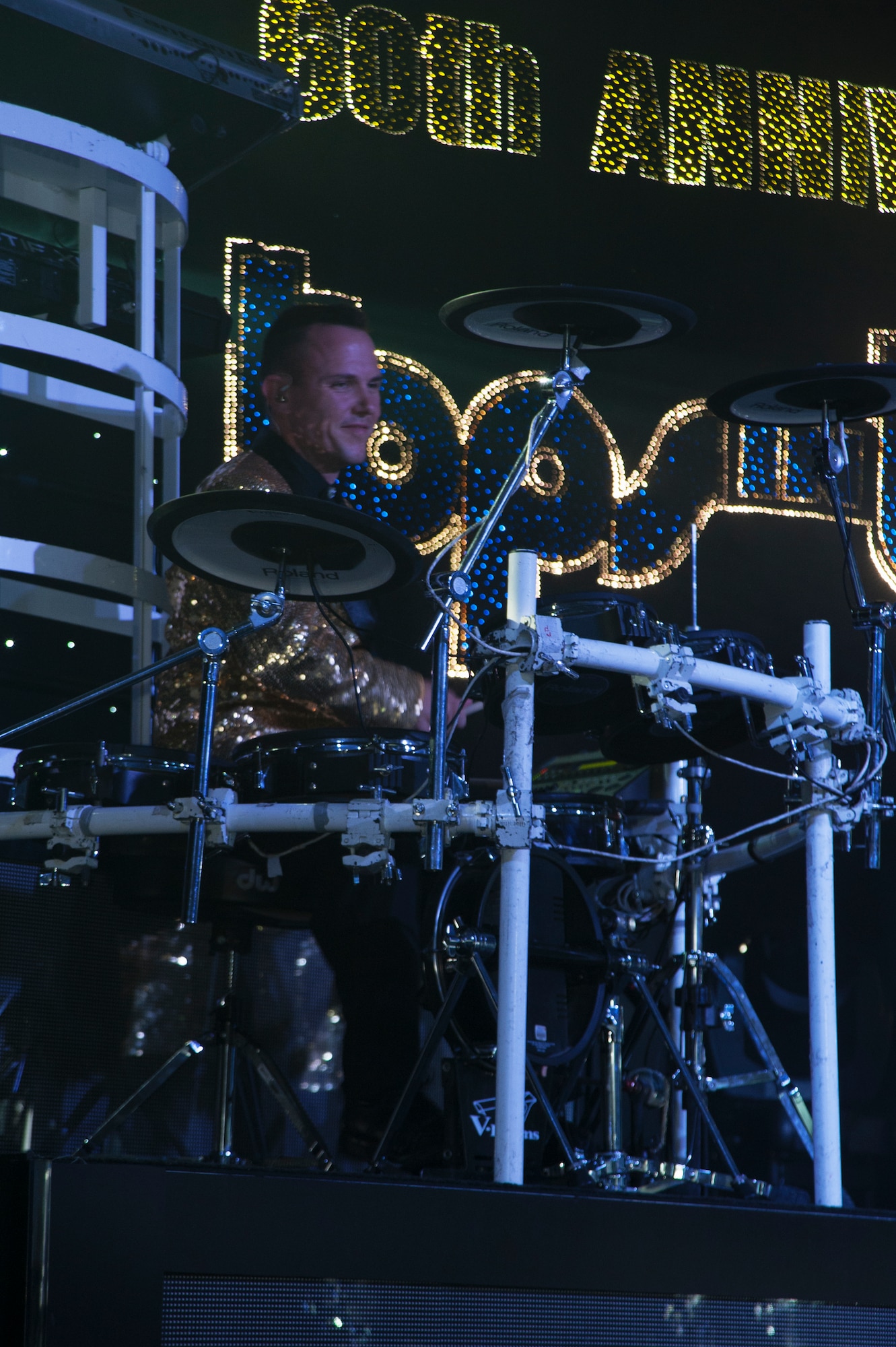 Staff Sgt. Jacob Becker, 576th Flight Test Squadron missile space systems electronic maintenance craftsman, and Tops In Blue Drummer, smiles on while playing the drums during a Tops In Blue performance July 11, 2014, Cabrillo High School, Lompoc, Calif. Celebrating 60 years of tradition, Tops In Blue performed for Vandenberg personnel, families and members of the local community. (U.S. Air Force photo by Senior Airman Armando Aparicio/Released)