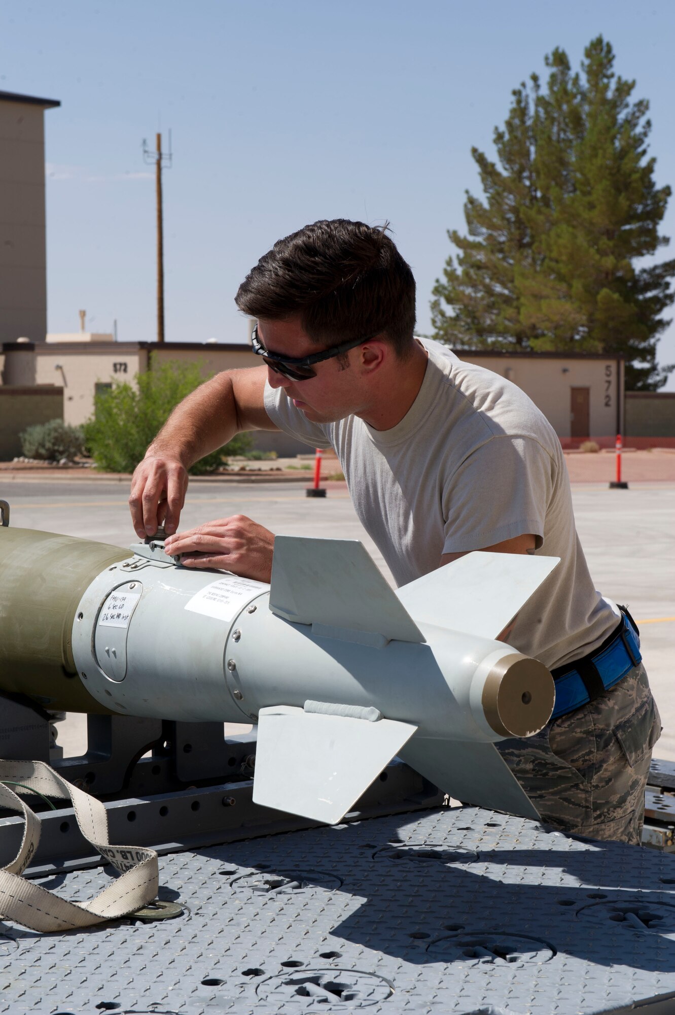 Senior Airman Nicholes Munoz, 54th Fighter Group F-16 Fighting Falcon weapons load crew 102 member, inspects a GBU-38 JDAM bomb during the third quarterly load crew competition at Holloman Air Force Base, N.M., July 11. The F-16 load crew participated in the competition to have their skills evaluated alongside the MQ-9 Reaper load crews. For the competition, points are awarded for weapons-loading, toolkit inspection, and uniform inspection. (U.S. Air Force Staff Sgt. E’Lysia A. Wray/Released)