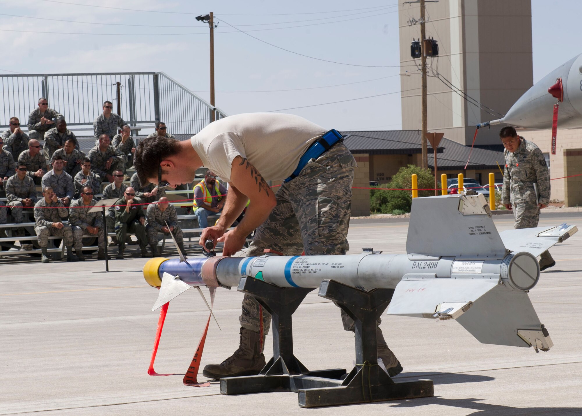 Senior Airman Nicholes Munoz, 54th Fighter Group F-16 Fighting Falcon weapons load crew 102 member, inspects an inert AIM-9 Sidewinder missile during the third quarterly load crew competition at Holloman Air Force Base, N.M., July 11. The F-16 load crew participated in the competition to have their skills evaluated alongside the MQ-9 Reaper load crews. For the competition, points are awarded for weapons-loading, toolkit inspection, and uniform inspection. (U.S. Air Force Staff Sgt. E’Lysia A. Wray/Released)