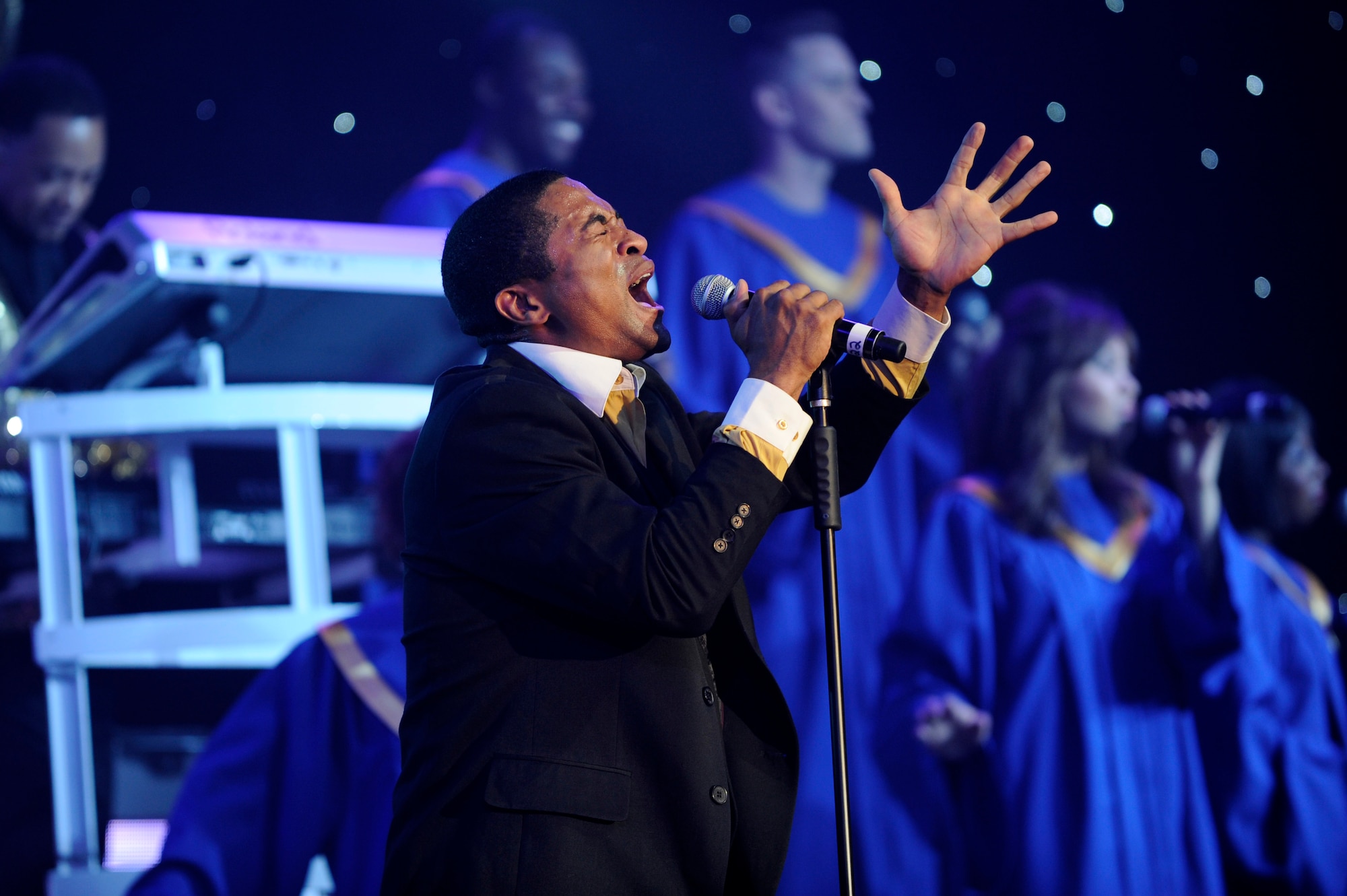 Senior Airman Charles Cooper, 509th Logistics Readiness Squadron vehicle operations journeyman, and Tops In Blue vocalist, belts out lyrics during a performance July 11, 2014, Cabrillo High School, Lompoc, Calif. Celebrating 60 years of tradition, Tops In Blue performed for Vandenberg personnel, families and members of the local community. (U.S. Air Force photo by Senior Airman Shane Phipps/Released)   