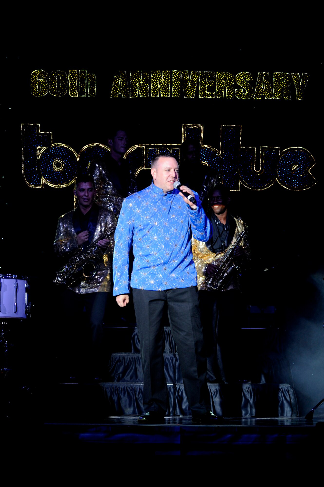 Tech. Sgt. David Young, 48th Fighter Wing command post craftsman and Tops In Blue vocalist, addresses the crowd during a performance July 11, 2014, Cabrillo High School, Lompoc, Calif. Celebrating 60 years of tradition, Tops In Blue performed for Vandenberg personnel, families and members of the local community. (U.S. Air Force photo by Senior Airman Shane Phipps/Released)   