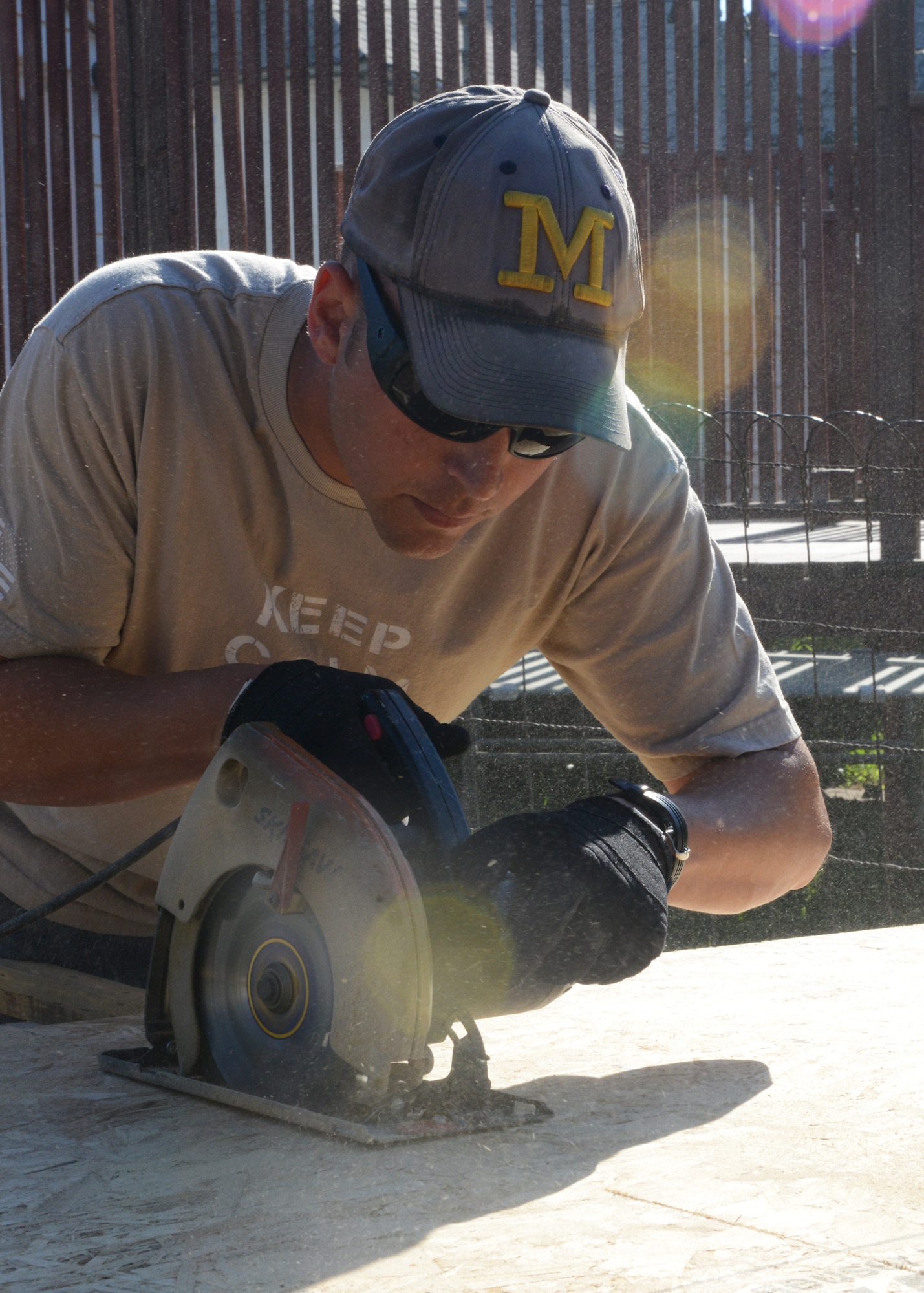 Senior Airman Brett Johnson, 341st Security Forces Squadron corrections supervisor, cuts plywood with a circular saw to complete the subfloor of a Habitat for Humanity home in Great Falls, Mont., July 12. Airmen interested in volunteering for Habitat can contact the base point of contact, Master Sgt. John Haywood at 731-4447. (U.S. Air force photo/Senior Airman Katrina Heikkinen) 