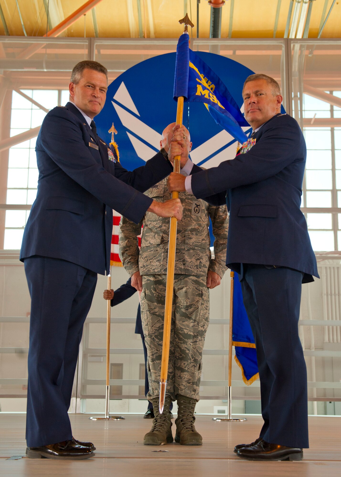 Colonel Kevin S. Bennett, 49th Mission Support Group outgoing commander, passes the 49th MSG’s guidon to Col. James Thompson, 49th Wing interim commander, symbolizing his stepping down from command during the 49th MSG change of command at Holloman Air Force Base, N.M., July 11. Colonel Robert G. Brown assumed command of the 49th MSG from Col. Kevin S. Bennett. The group is the home to the 49th Logistics Readiness Squadron, 49th Communications Squadron, 49th Contracting Squadron, 49th Security Forces Squadron, 49th Civil Engineer Squadron and the 49th Force Support Squadron. (U.S. Air Force photo by Staff Sgt. E’Lysia A. Wray/Released)