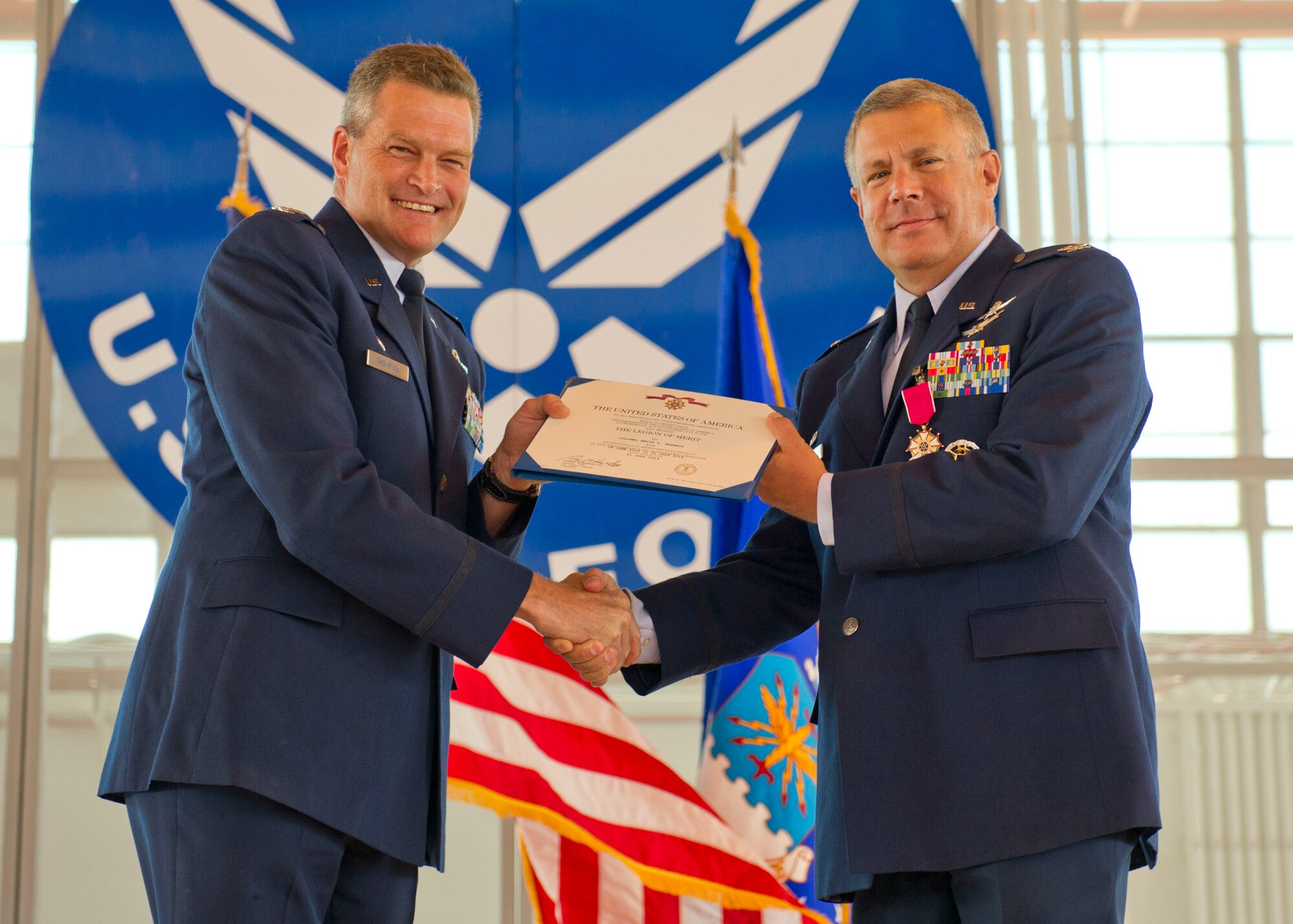 Colonel Kevin S. Bennett, 49th Mission Support Group outgoing commander, receives a Meritorious Service Medal from Col. James Thompson, 49th Wing interim commander, during the 49th MSG change of command at Holloman Air Force Base, N.M., July 11. Colonel Robert G. Brown assumed command of the 49th MSG from Col. Kevin S. Bennett. The group is the home to the 49th Logistics Readiness Squadron, 49th Communications Squadron, 49th Contracting Squadron, 49th Security Forces Squadron, 49th Civil Engineer Squadron and the 49th Force Support Squadron. (U.S. Air Force photo by Staff Sgt. E’Lysia A. Wray/Released)