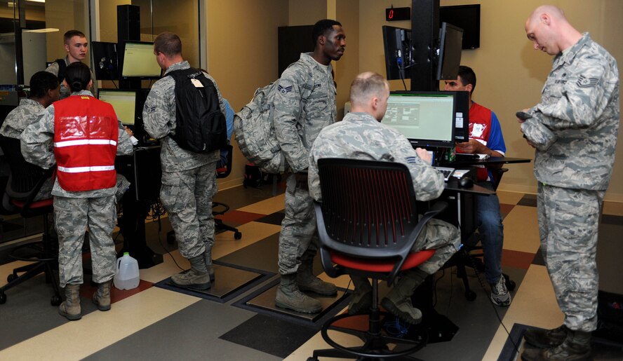 Approximately 170 Airmen processed through the Deployment Center at Ellsworth Air Force Base, S.D., July 11, 2014 to start their participation in Red Flag ¬14-3. Red Flag, a realistic combat training exercise involving air, space and cyber forces, is conducted at Nellis Air Force Base, Nev. With 1,900 possible targets, realistic threat systems and an opposing enemy force that cannot be replicated anywhere else in the world, Nellis AFB is the home of a simulated battlefield, providing combat air forces with the ability to train to fight together in a peacetime environment. (U.S. Air Force photo by Senior Airman Hailey R. Staker/Released)