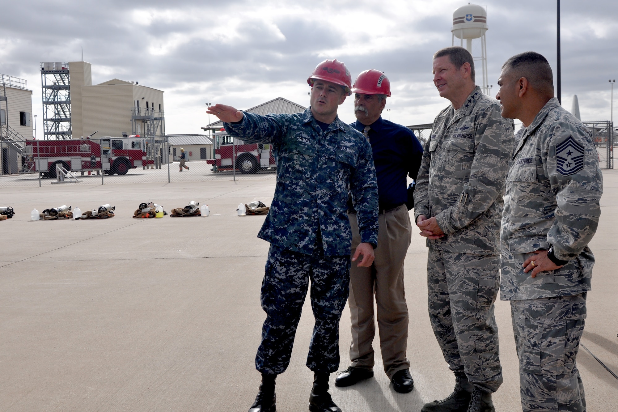 GOODFELLOW AIR FORCE BASE, Texas – Navy Petty Officer 2nd Class Trevor D. Grimes, Department of Defense Louis F. Garland Fire Academy Instructor, explains to Gen. Robin Rand, commander of Air Education and Training Command and Chief Master Sgt. Gerardo Tapia Jr., AETC command chief master sergeant, about the Fire Academy academics, July 11. The Fire Academy is host to approximately 15 advanced Fire Protection courses and a Fire Protection Apprentice Course. (U.S. Air Force photo/ Airman 1st Class Breonna Veal)