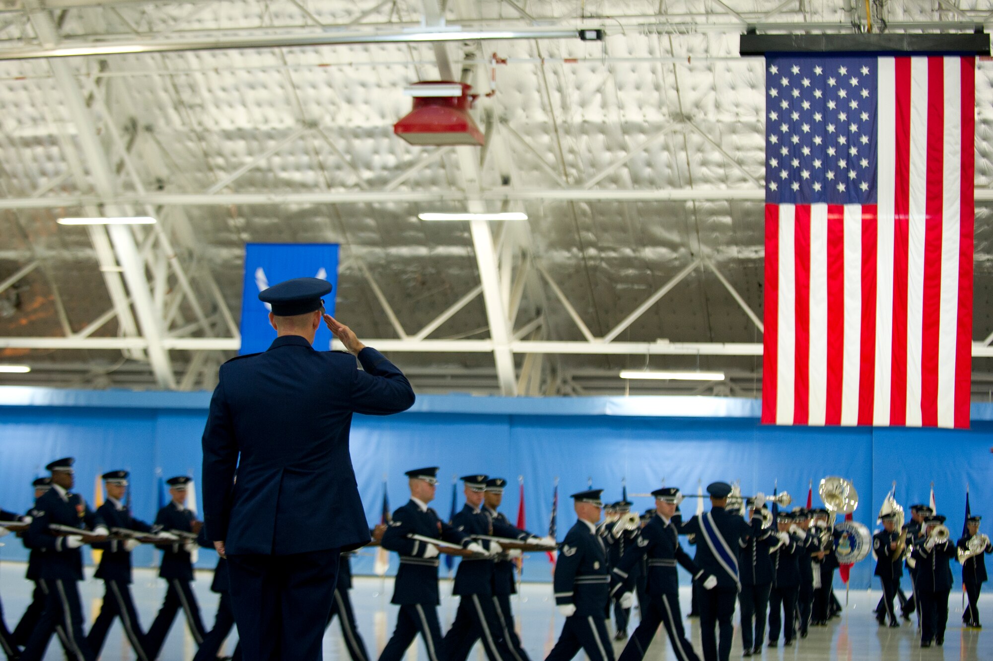 Col. Bill Knight salutes U.S. Air Force Band and Honor Guard members as they perform a pass in review at his change of command ceremony at Joint Base Andrews, Md., July 14, 2014. The ceremony transfers 11th Wing/JBA command from Knight to Col. Bradley Hoagland. (U.S. Air Force photo/Senior Airman Mariah Haddenham)