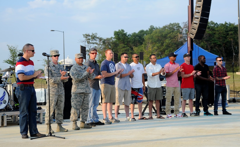 Col. Bill Knight, 11th Wing and Joint Base Andrews commander, left, thanks members of the 11th Civil Engineer Squadron, July 12, 2014, for their dedication and hard work on the newly constructed Heritage Park on Joint Base Andrews, Md.  The park will play host to three concerts this summer, designed to show appreciation to the local community for their support and showcase JBA's dedicated Airmen. This was the second concert in the series. (U.S. Air Force photo/Tech. Sgt. Brian Ferguson) 