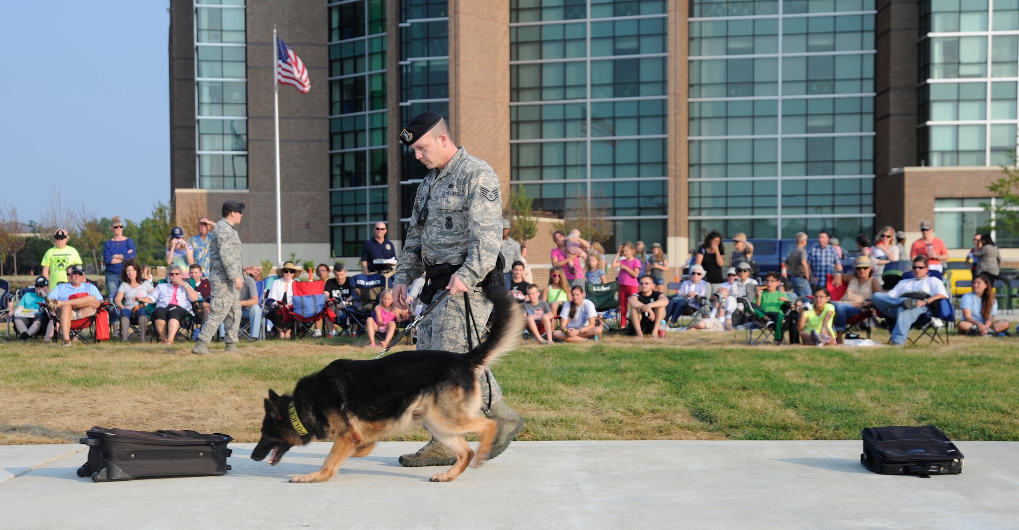 Members of the 11th Security Forces Squadron give a working dog demonstration to spectators at the Joint Base Andrews Heritage Park Concert, July 12, 2014. The concert series was designed to show appreciation to the local community for their support and showcase JBA's dedicated Airmen. This was the second of three concerts scheduled for this summer. (U.S. Air Force photo/Tech. Sgt. Brian Ferguson)
