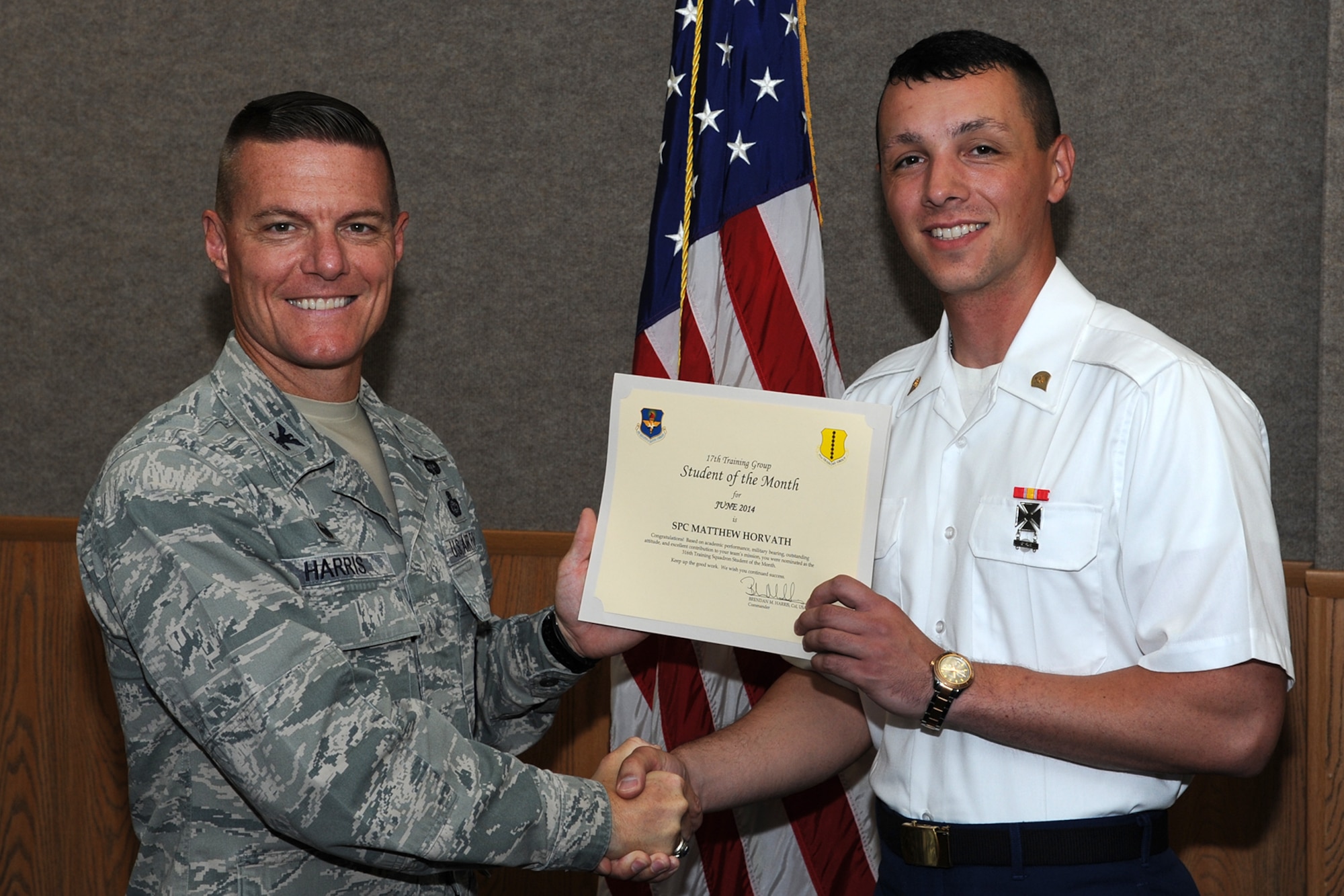 GOODFELLOW AIR FORCE BASE, Texas -- Col. Brendan M. Harris, 17th Training Group Commander, presents the 316th Training Squadron Enlisted Student of the Month award for June 2014 to Army Spc. Matthew Horvath July 11. (U.S. Air Force photo/ Senior Airman Michael Smith)