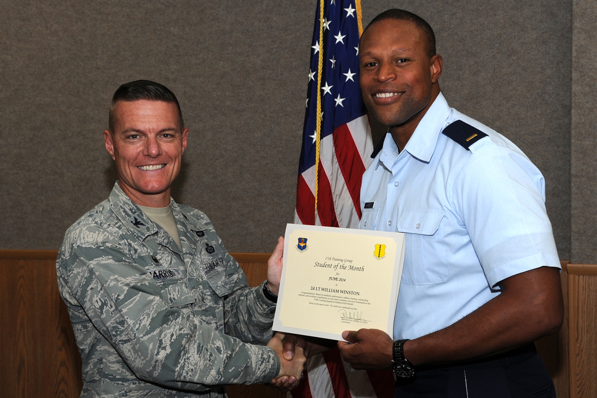 GOODFELLOW AIR FORCE BASE, Texas -- Col. Brendan M. Harris, 17th Training Group Commander, presents the 315th Training Squadron Officer Student of the Month award for June 2014 to 2nd Lt. William Winston July 11. (U.S. Air Force photo/ Senior Airman Michael Smith)