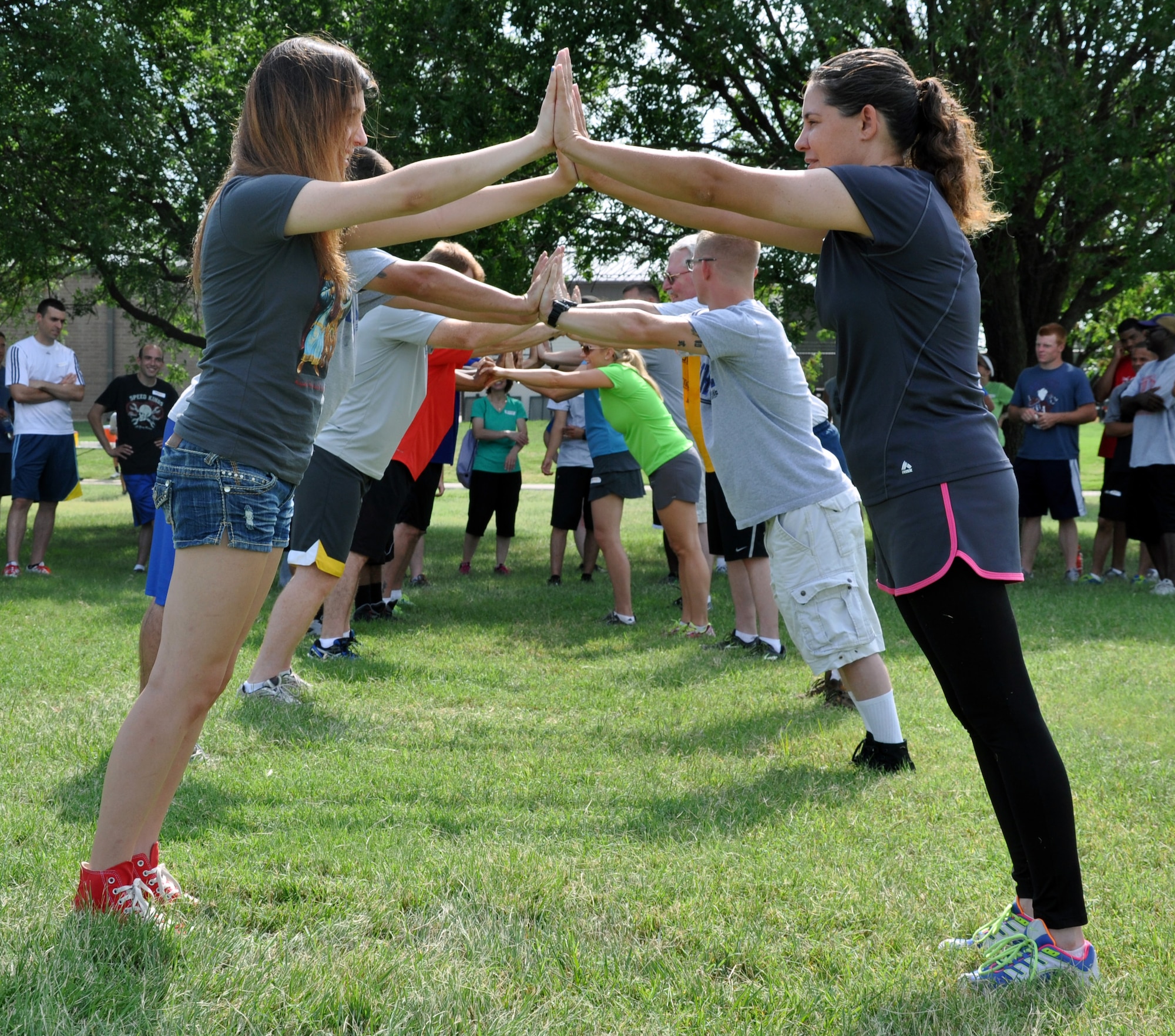 Members of the 931st Air Refueling Group overcome a teambuilding challenge during the Group's annual Wingman Day at McConnell Air Force Base, Kan., July 13, 2014.  Wingman Day is a day designated to promote resiliency, teamwork and trust among Air Force members. The 931 ARG Wingman Day incorporated several activities that required interaction, teamwork and trust to accomplish, as well as briefings on taking care of and supporting fellow Airmen. (U.S. Air Force photo by Capt. Zach Anderson)
 
