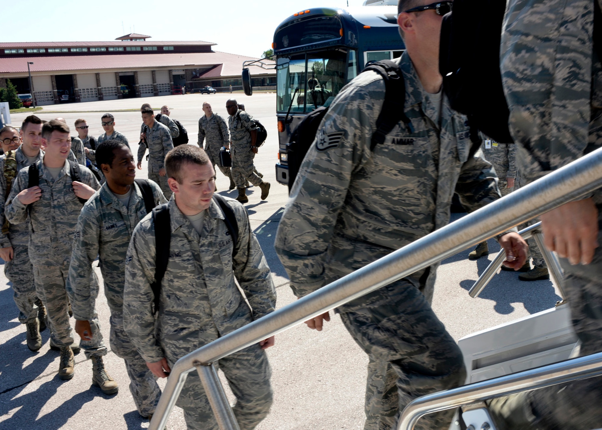 Ellsworth Airmen board a plane on the flight line at Ellsworth Air Force Base, S.D., en route to Nellis Air Force Base, Nev. for a Red Flag training exercise July 11, 2014. The exercise features aerial combat training scenarios designed to challenge and prepare participants for real-world combat and includes live munition bombing runs on the Nevada Test and Training Range . (U.S. Air Force photo by Senior Airman Anania Tekurio/Released)