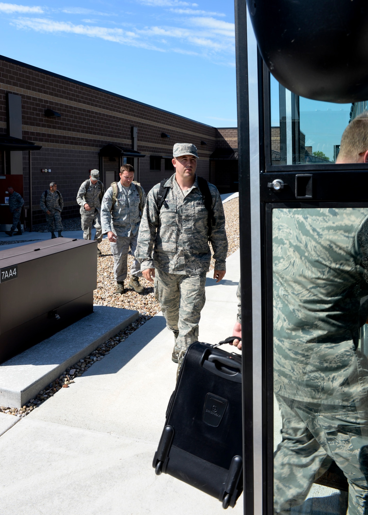 Airmen depart the Deployment Center at Ellsworth Air Force Base, S.D., to take part in Red Flag, an exercise being conducted at Nellis Air Force Base, Nev., July 11, 2014. Red Flag is a two-week aerial combat training exercise designed to train pilots from NATO and allied nations in planning and executing a wide-variety of combat missions. (U.S. Air Force photo by Senior Airman Anania Tekurio/Released)