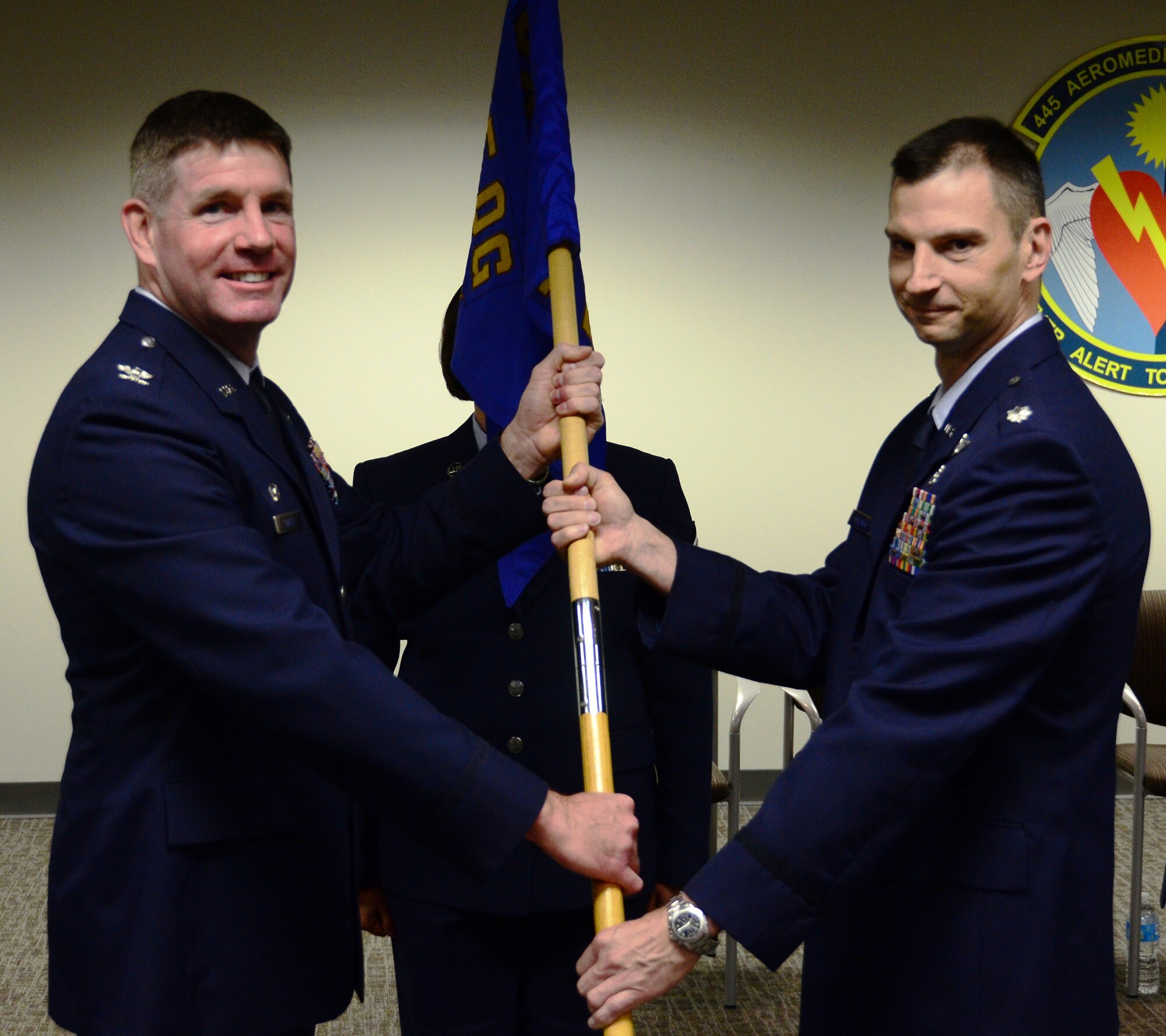 WRIGHT-PATTERSON AIR FORCE BASE, Ohio - Col. David Owens, 445th Operations Group commander, passes the guidon to Lt. Col. Christopher Matlack, incoming 445th Aeromedical Evacuation Squadron commander, during the 445th Aeromedical Evacuation Squadron Change of Command ceremony June 7, 2014. (U.S. Air Force photo/Senior Airman Devin Long)