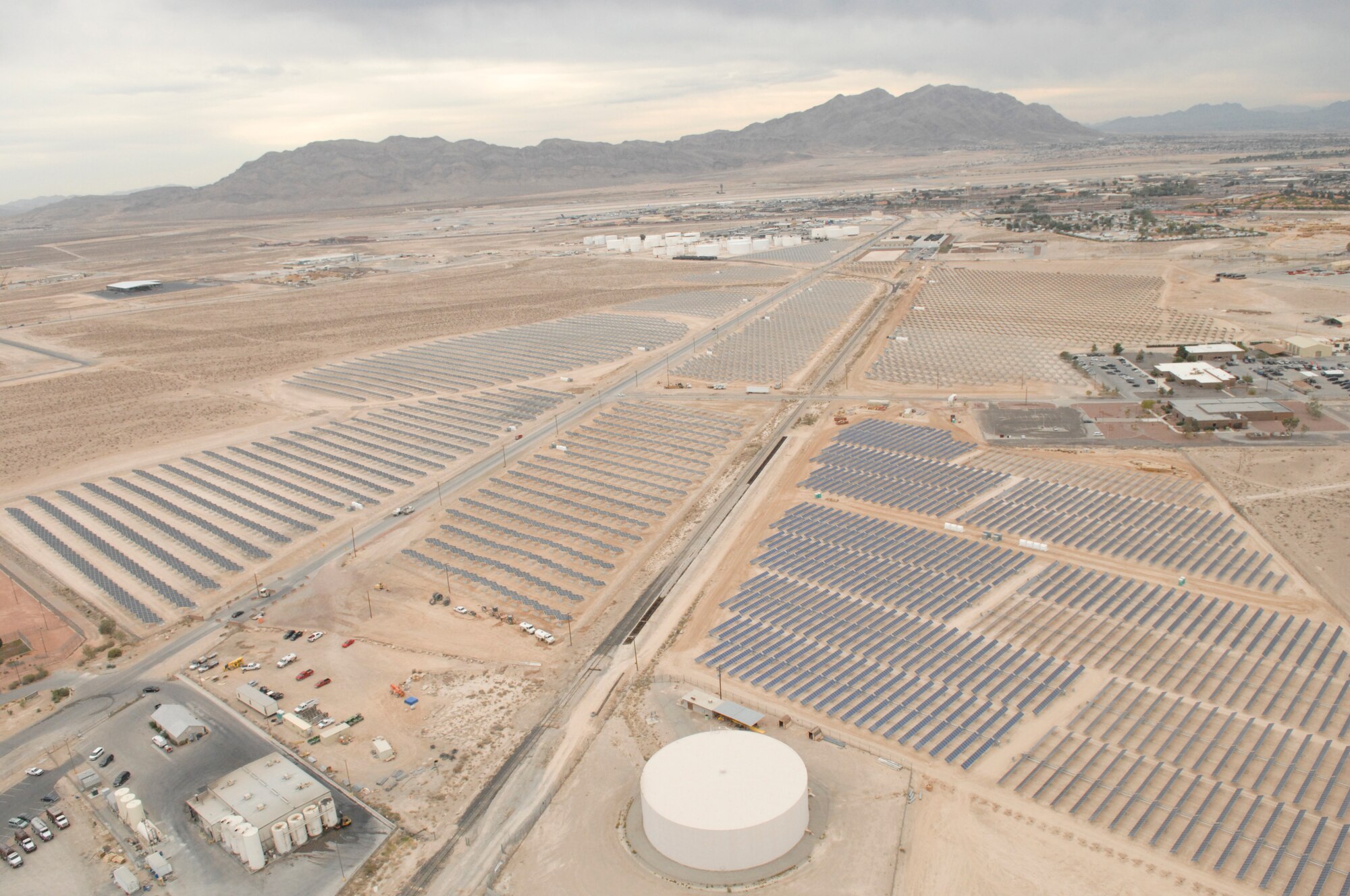 Nellis Air Force Base, Nev., plans to more than double its solar power production pictured here in 2007.  Recently, the Air Force signed a land lease with NV Energy, paving the way for construction of a 19-megawatt solar photovoltaic power system. NV Energy will provide a secondary substation and a transmission line as an in-kind consideration to the government for the lease. The substation will provide energy security and mission assurance by providing a redundant primary electric feed to the base. (U.S. Air Force photo)