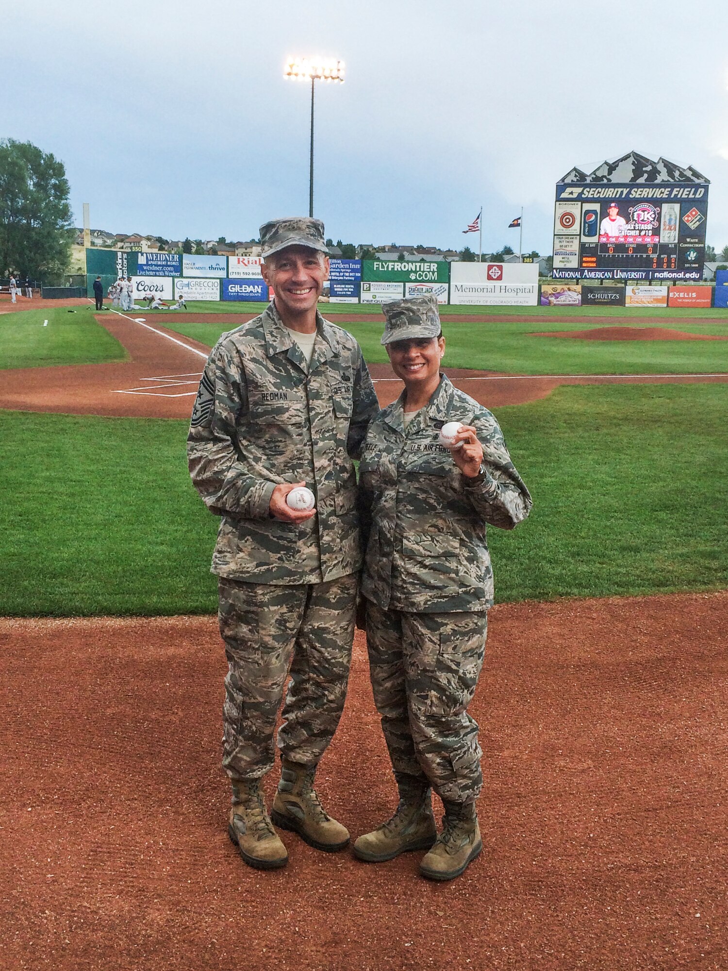 COLORADO SPRINGS, Colorado – Chief Master Sgt. Richard Redman, outgoing 21st Space Wing command chief, and Chief Master Sgt. Idalia Peele, incoming 21st SW command chief, threw out the ceremonial first pitch July 3 at the Sky Sox game. Peele took over as the wing command chief July 14. The Sky Sox beat the Oklahoma City RedHawks 6-2. (U.S. Air Force photo)